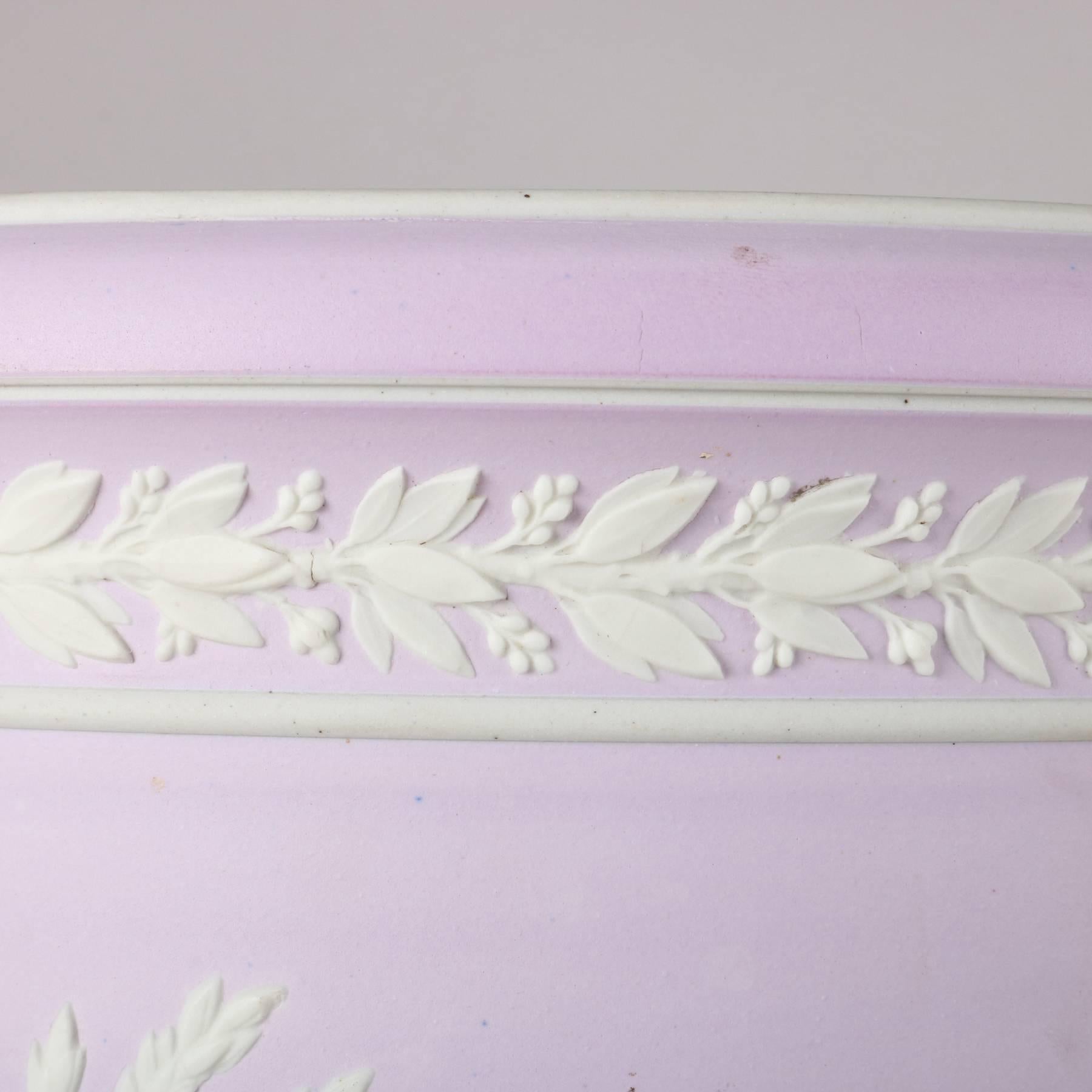 Antique English wedgewood school lilac porcelain planter (or small jardinière) features ivory Jasperware style motif of cherubs and classical figures in garden setting, 19th century.

Measures: 8.5