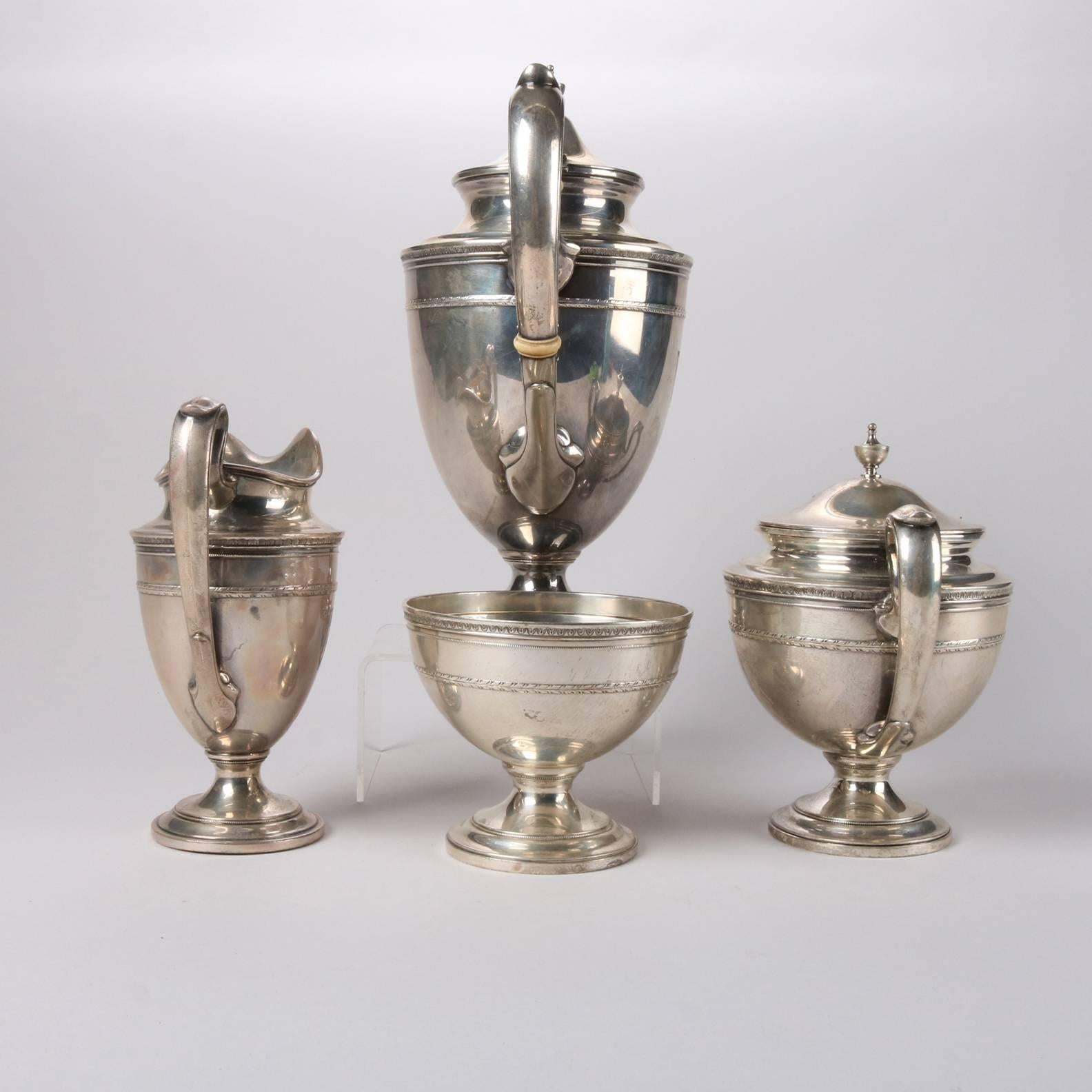 Antique English Gorham Edgeworth sterling silver four-piece tea set features footed tea pot, covered sugar, creamer, and waste bowl, hallmarked on bases, 