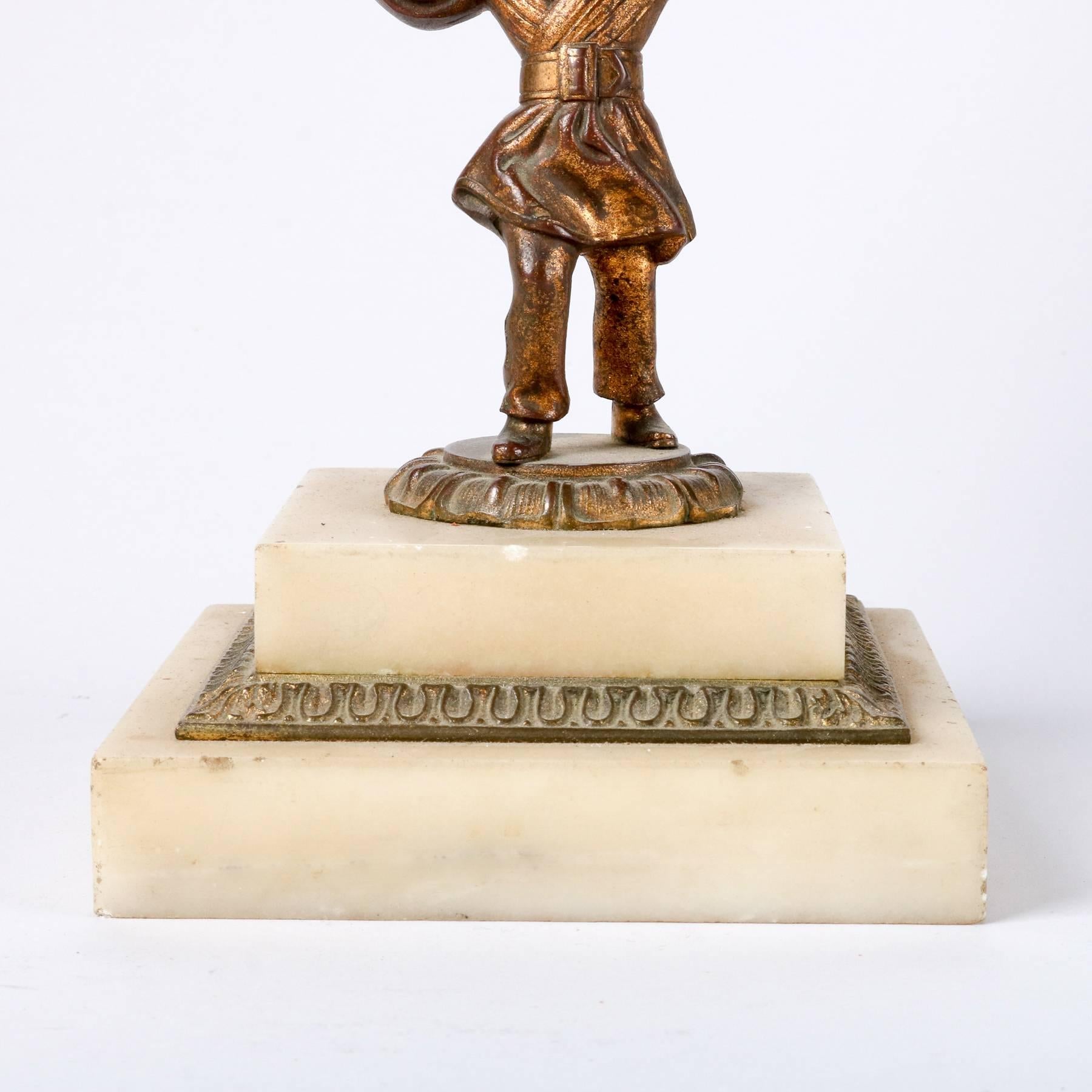 Antique early original figural solar lamp features cast bronze boy supporting font with cut crystals and etched frosted glass shade and seated on a stepped marble base, 19th century

Measures: 20