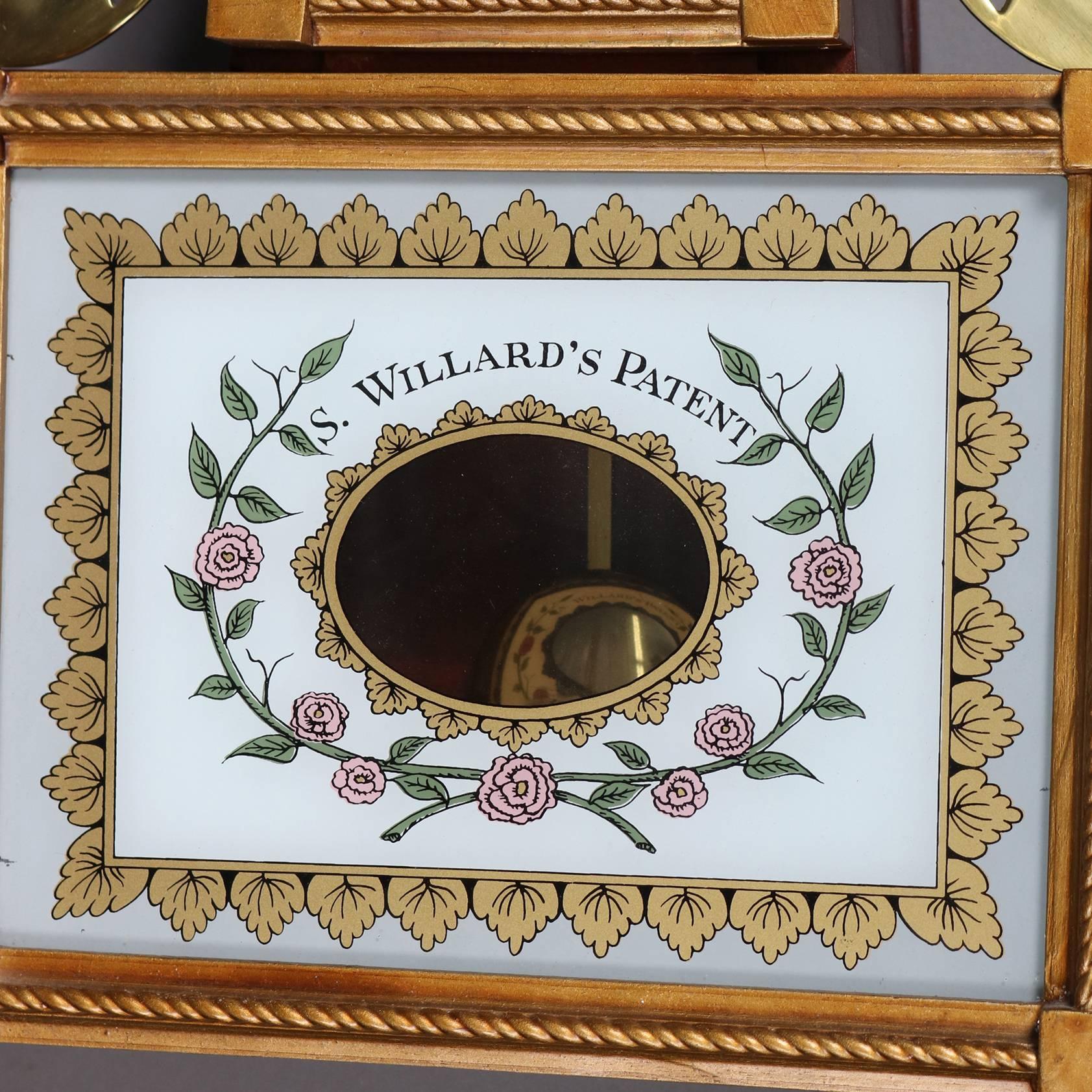 Federal style banjo wall clock features Mahogany gilt decorated case with pierced brass trim, rose floral with urn painted panels, 