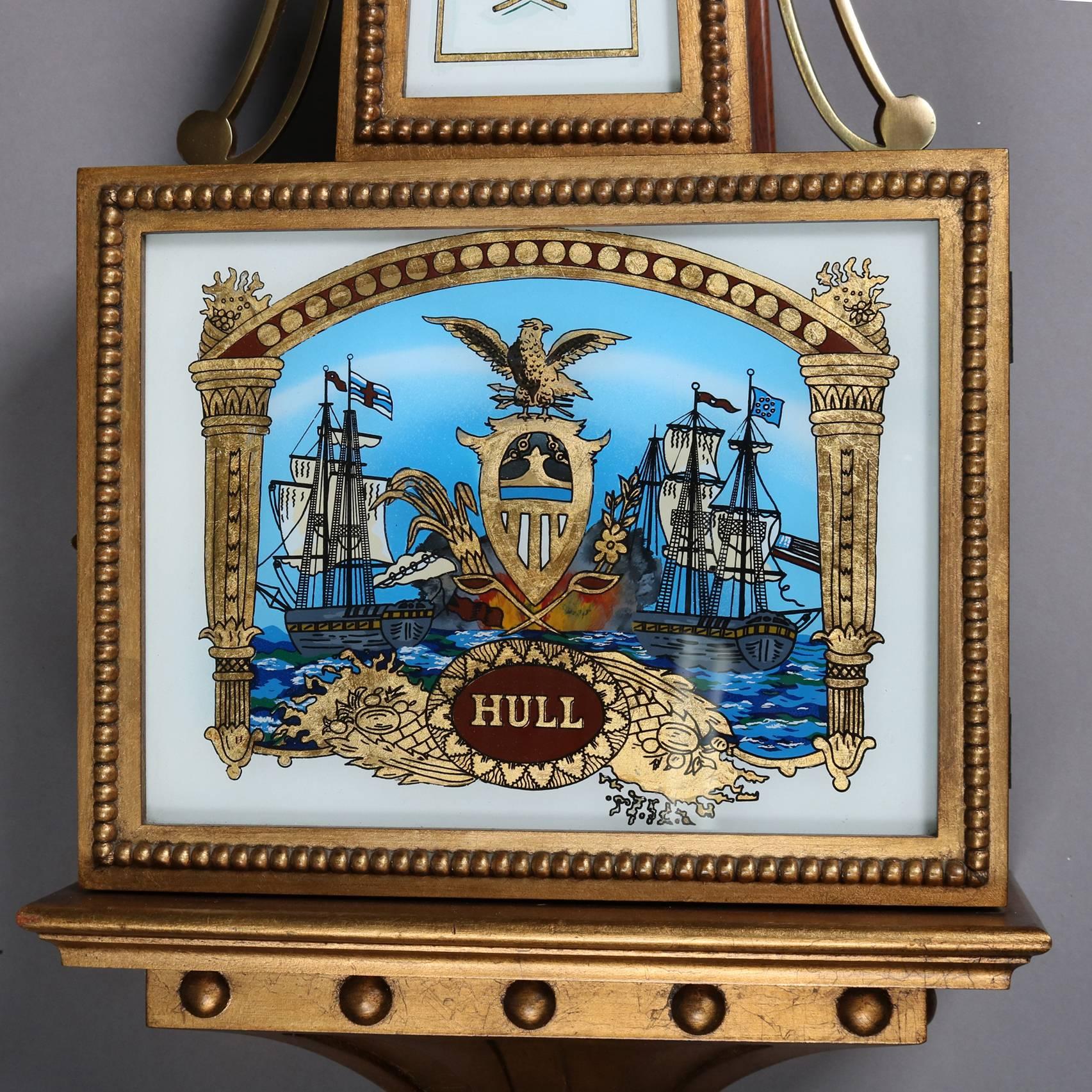 Federal style reproduction Aaron Willard nautical banjo wall clock by Colonial of Zeeland, MI for The Henry Ford Museum features gilt case with painted glass panels of maritime scene of tall mast ships and central shield and 