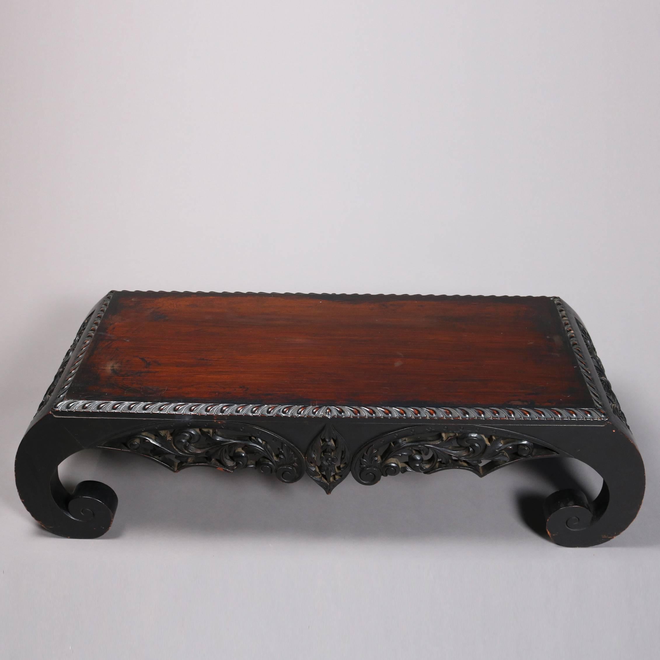 Antique ebonized and heavily carved Chinese tea table features pierced foliate apron, scroll legs, 20th century

Measures - 13