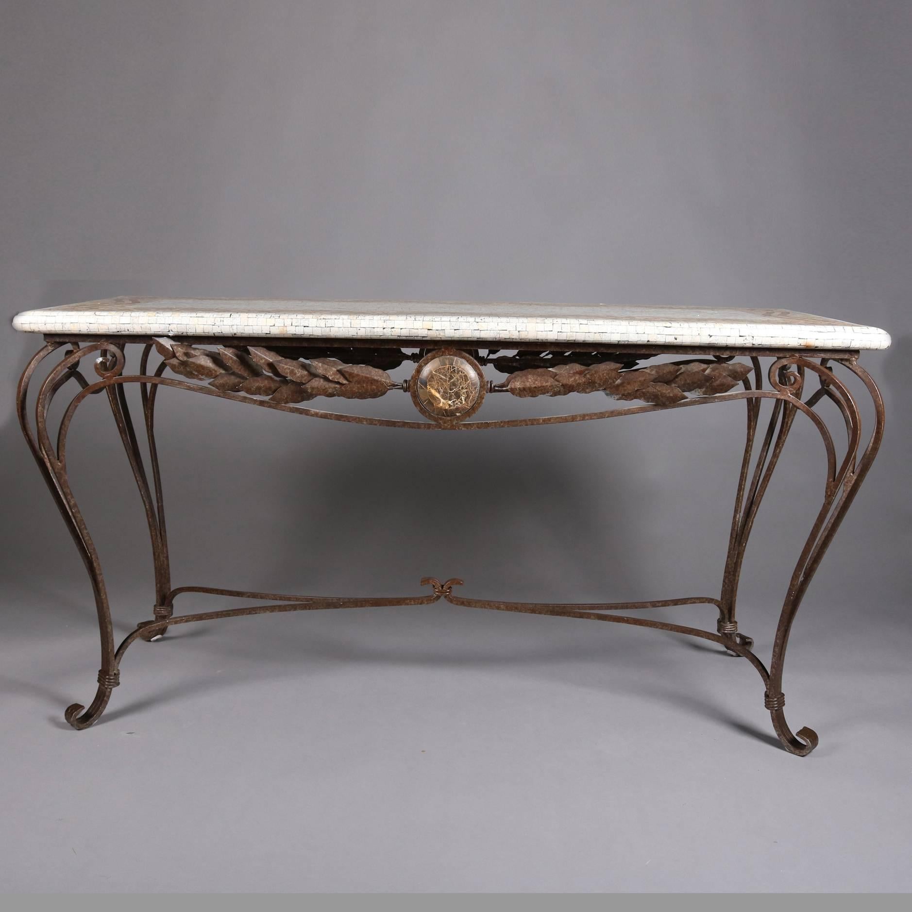 Italian hall table features tile mosaic on composite plaster top above wrought iron base with scroll cabriole legs, apron with central medallion flanked by stylized leaves, 20th century

Measures: 30.5