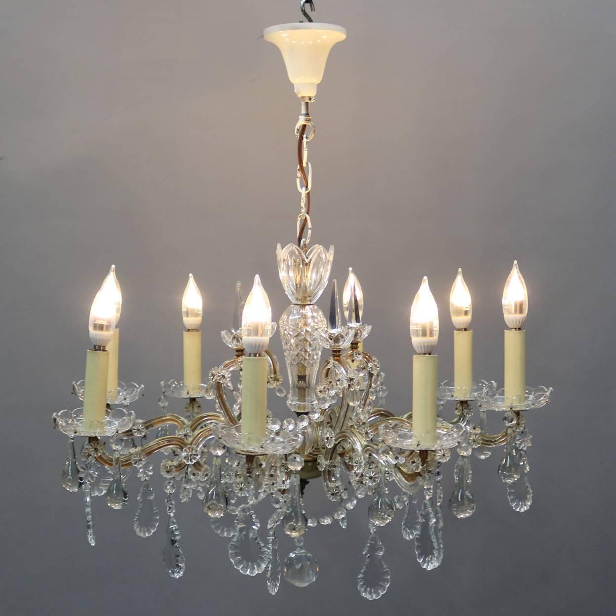 Continental French chandelier features bronze frame with cut crystal bodice and eight cut crystal and prism laden scroll arms terminating in candle lights, newly rewired, 20th century

Measures: 29