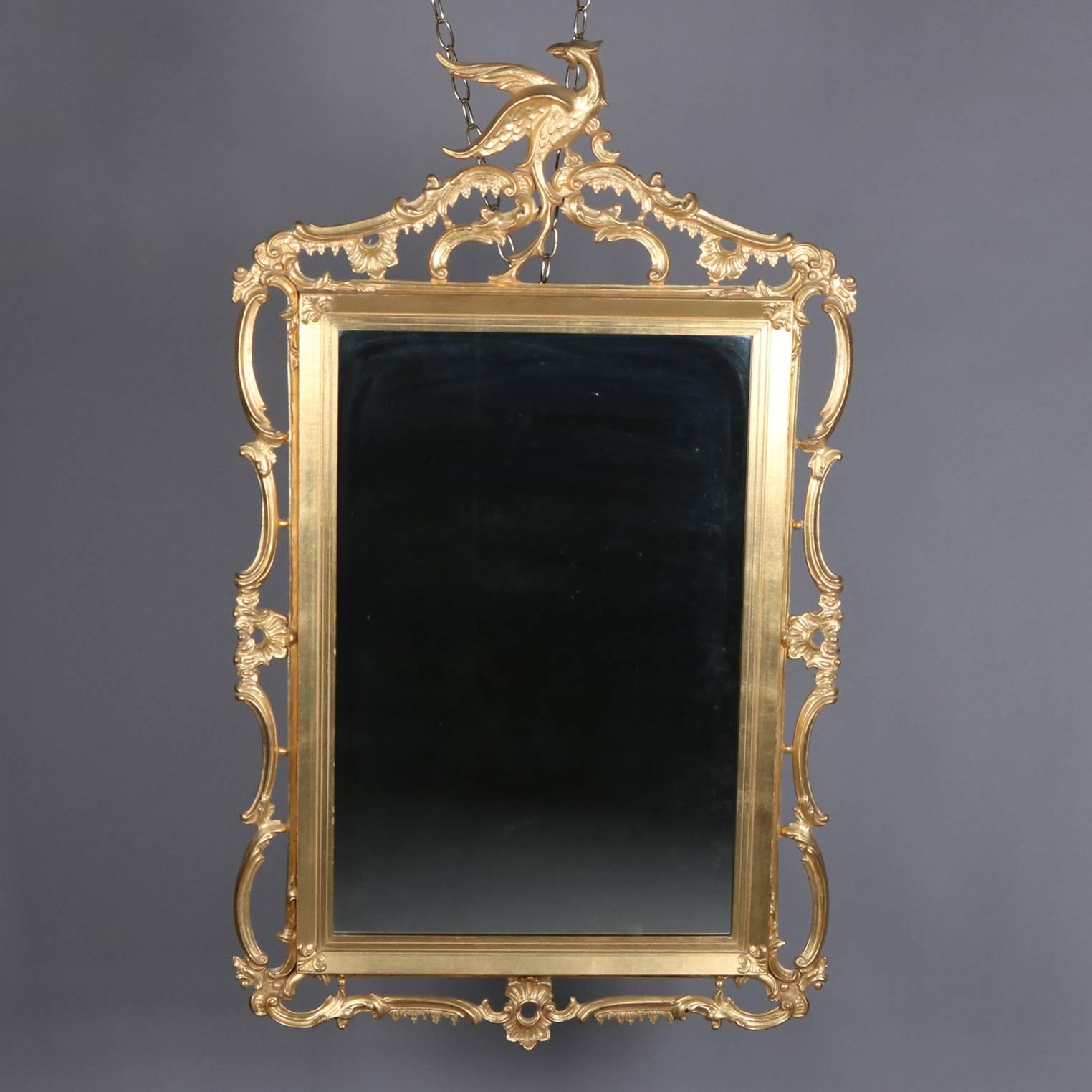 Federal Chippendale style giltwood wall mirror features pierced foliate, gadroon floral, and scroll form frame with Phoenix crest, 20th century

Measures: fr: 50
