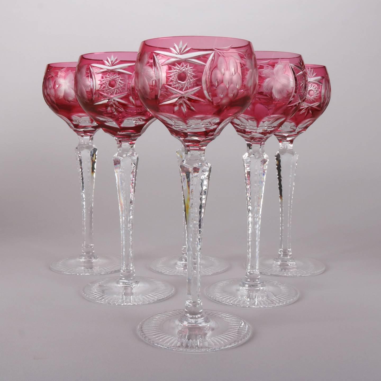 Antique 14-peice cranberry glass cut to clear liqueur set includes two decanters, six wine glasses and six cordial glasses, 19th century.
 