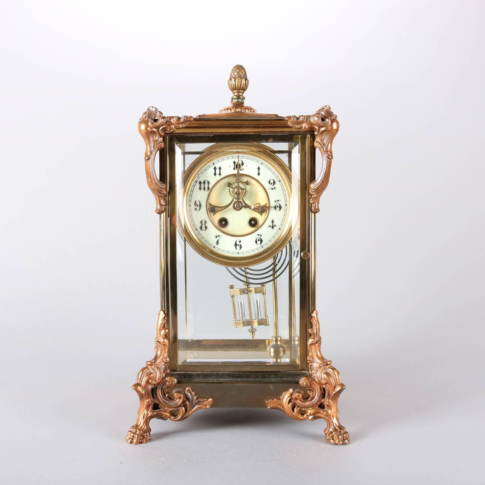 Antique French style crystal regulator mantel clock by Gilbert Clock Co. features gilt bronze paw and foliate form attachments, glass panels, the enameled dial with open escapement and Arabic numerals, 19th century

Measures: 15