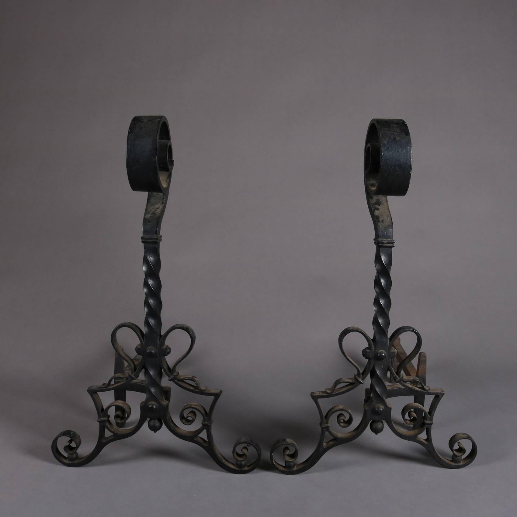 Pair of antique Arts & Crafts Mission Yellin School andirons by Bradley and Hubbard feature wrought iron construction with spiral scroll finial, twisted shafts and seated on scrollwork legs, signed B&H, early 20th century.

Measures: 24