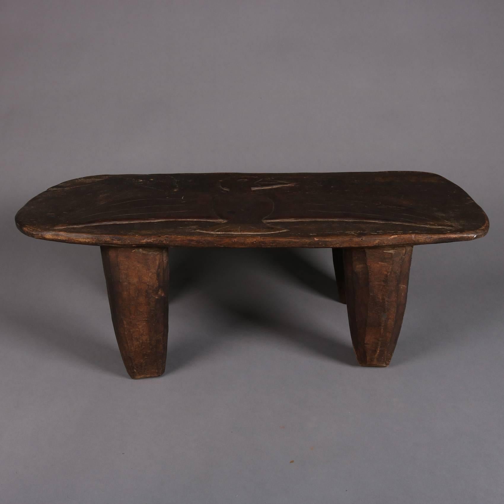Antique Folk Art primitive low bench features plank board seat with central Oaxacan carved spread eagle and seated on four carved and tapered legs, 19th century

Measures: 10.5