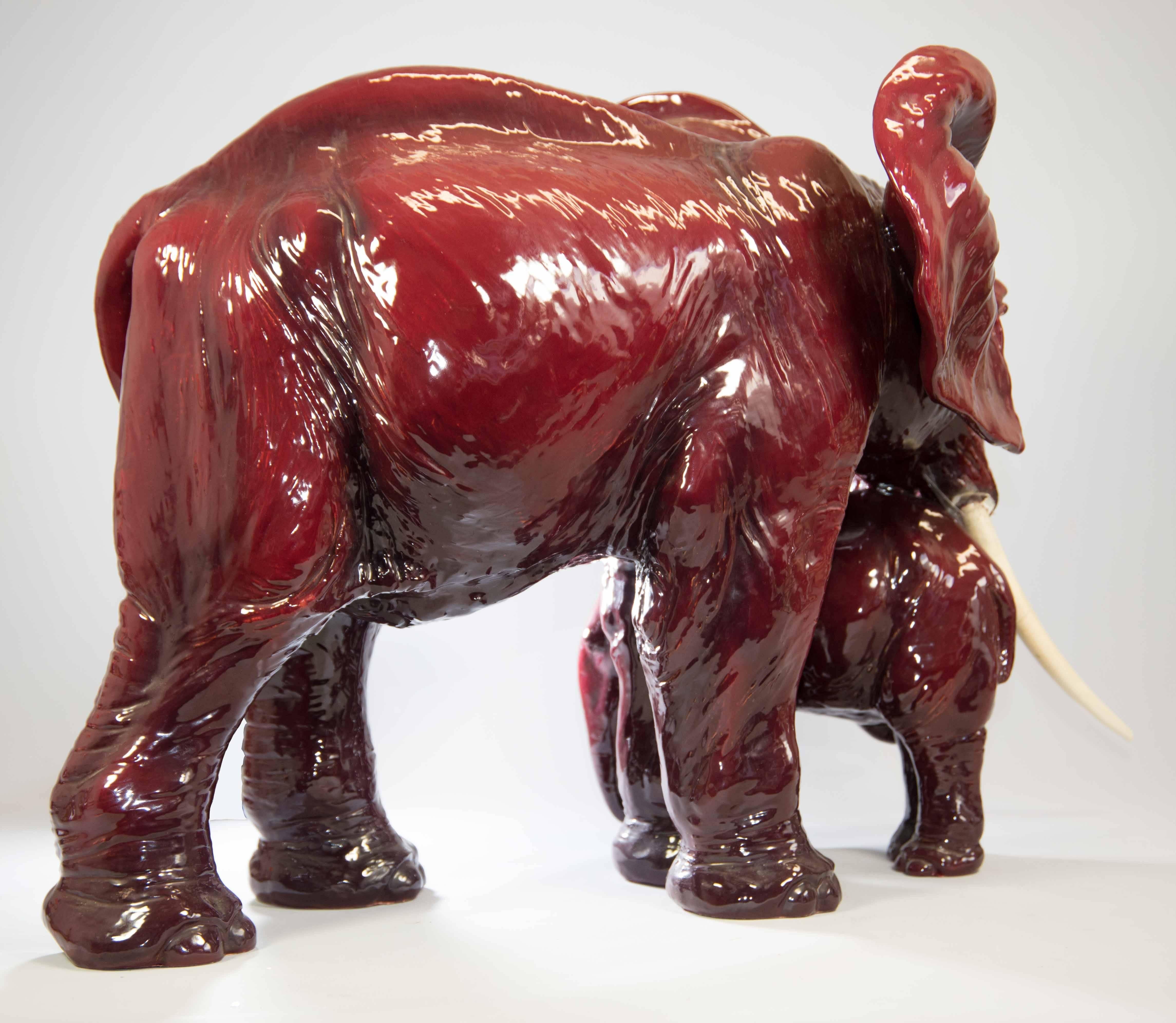 Large red porcelain elephant made by Guido Cacciapuoti, signed on belly.
One of tusks has been broken, not real ivory but a composite material, and should be repaired. The damage is close to the root of the tooth, a repair can be done invisibly.