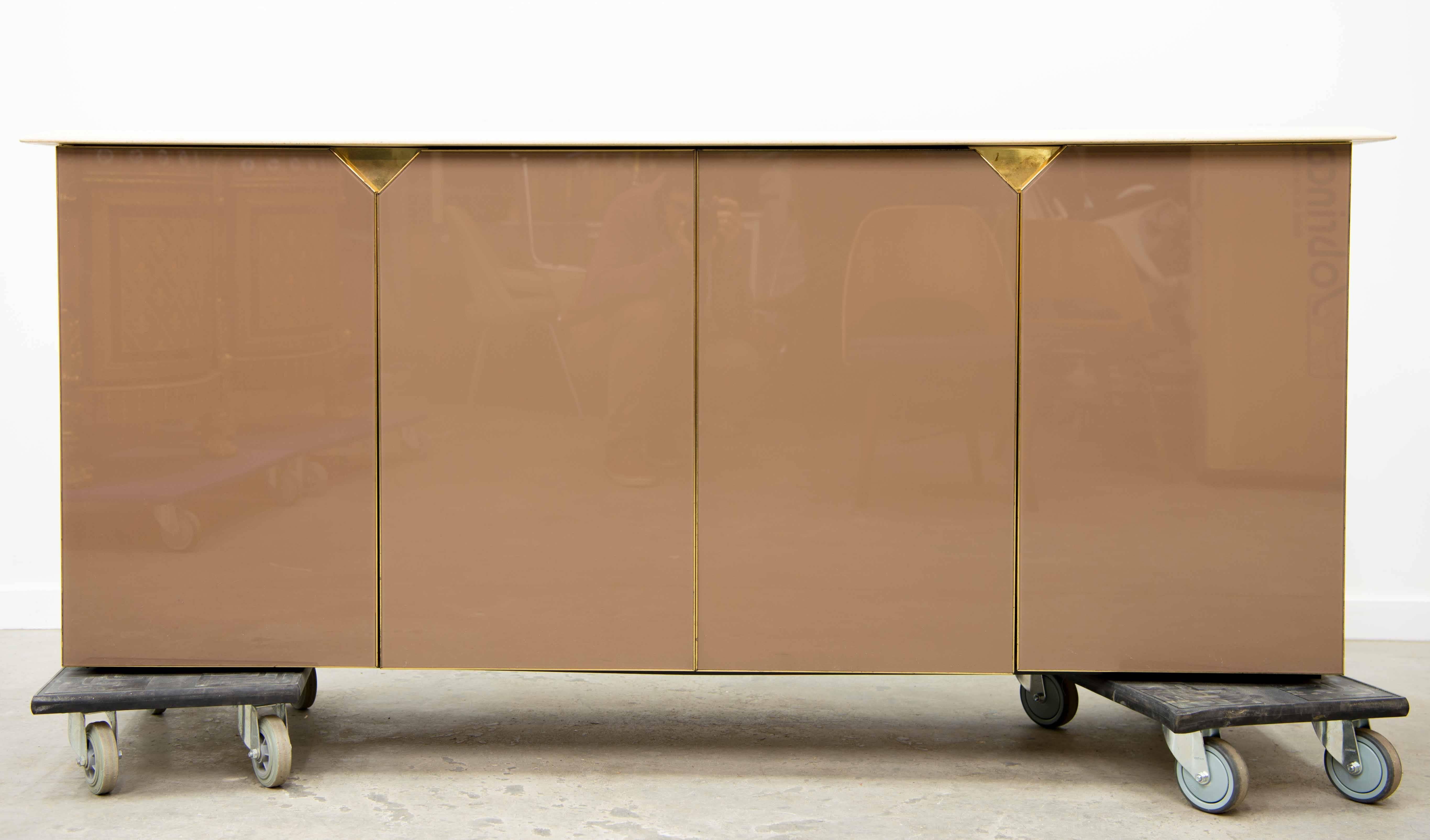 Travertine top, brass and glass on sides
Made by Belgochrom, 1970.