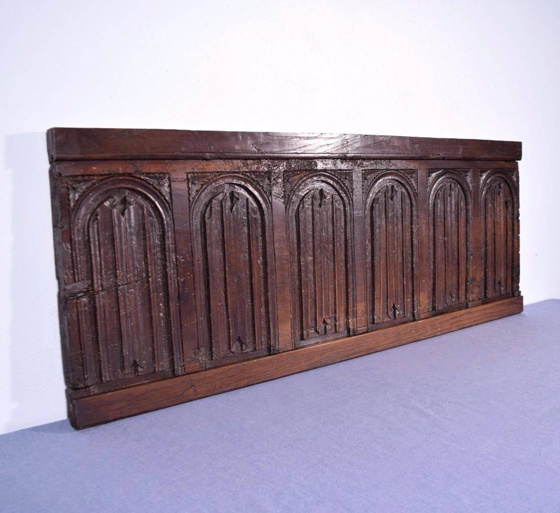 This antique panel is from France and it dates to the late Gothic period of the 1500s. This rare old panel is large enough to be used as a wall-mounted headboard-a beautiful piece with over 500 years of history. It is made from solid walnut. This