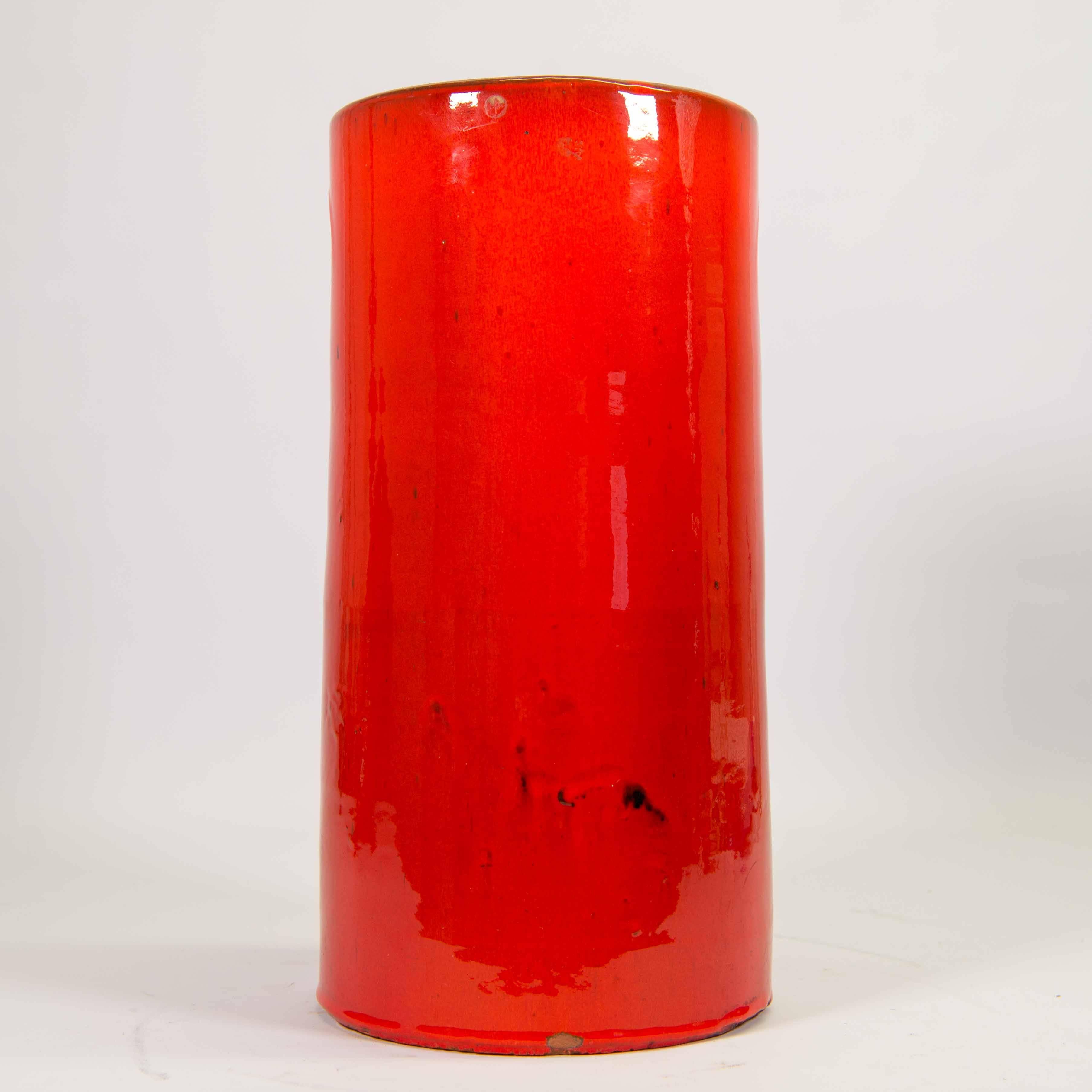 We have to offer this spectactular umbrella stand in ceramic with red glazed finish on top. This stand was made by Amphora, a Belgian ceramic factory in Beernem. They were very close related to Perignem. 

Umbrella stand has some small chips near