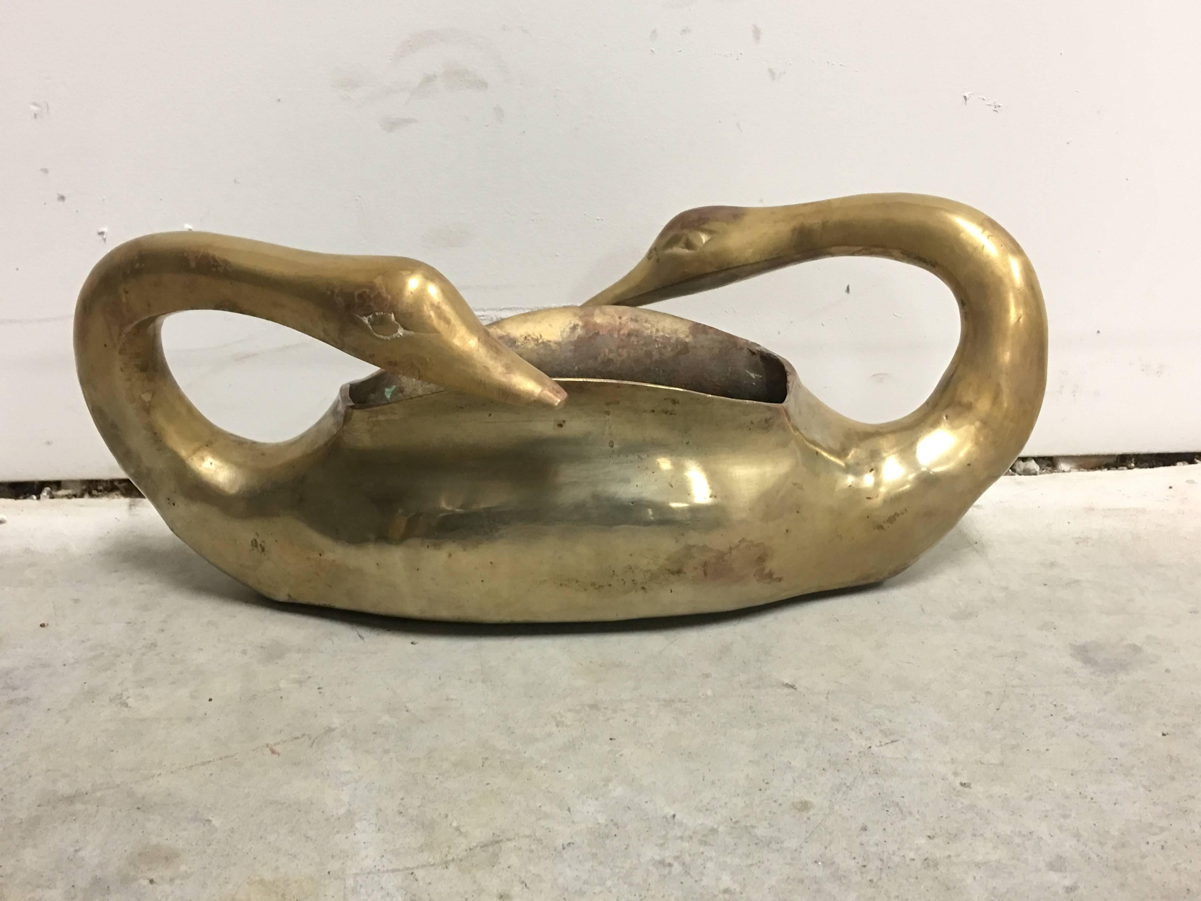 Offered is a stunning, 1950s double headed swan brass planter. Substantial weight.