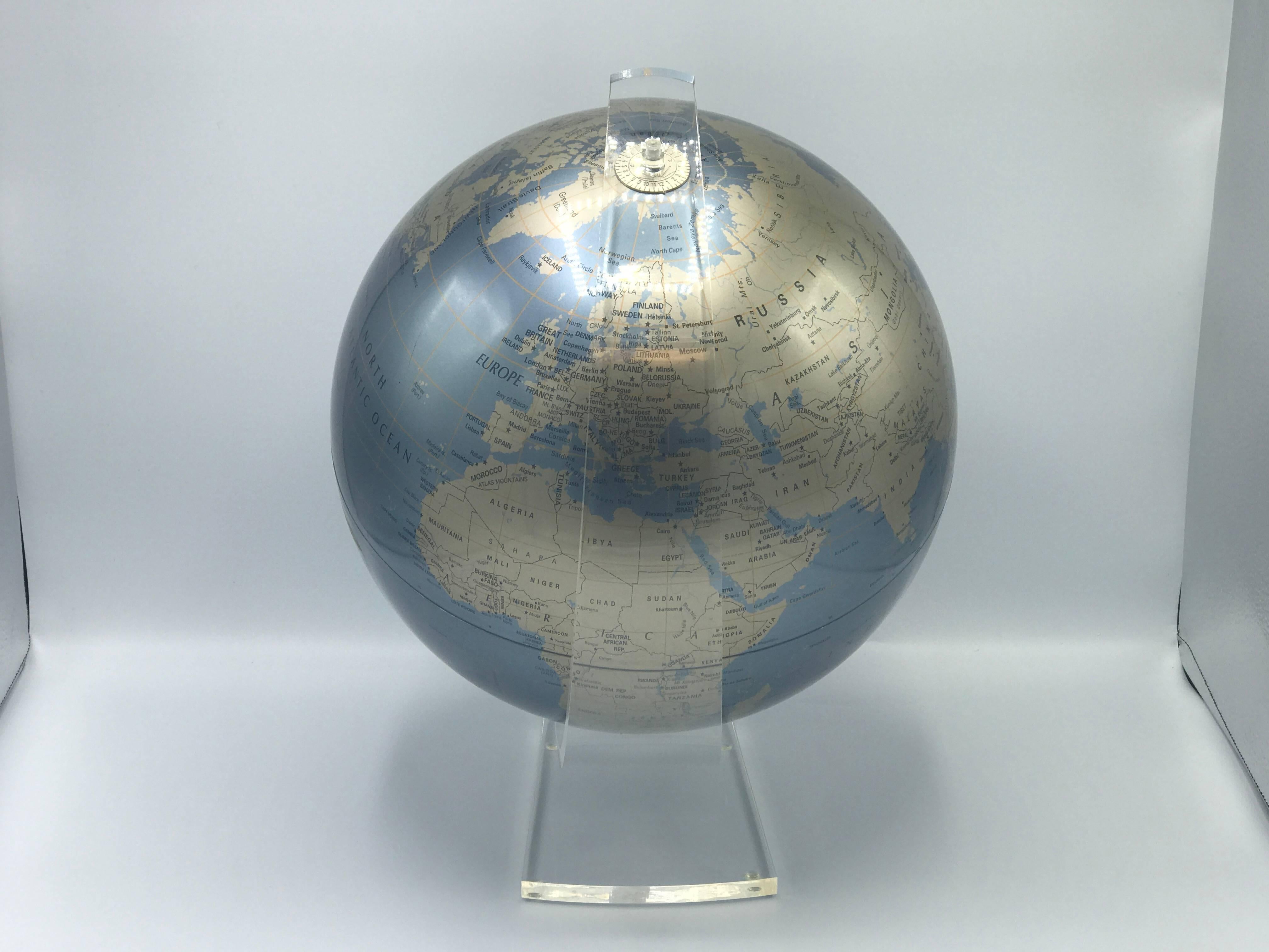 Offered is a gorgeous, 1960s globe on a sculptural Lucite stand. The globe is a beautiful metallic blue and gold.