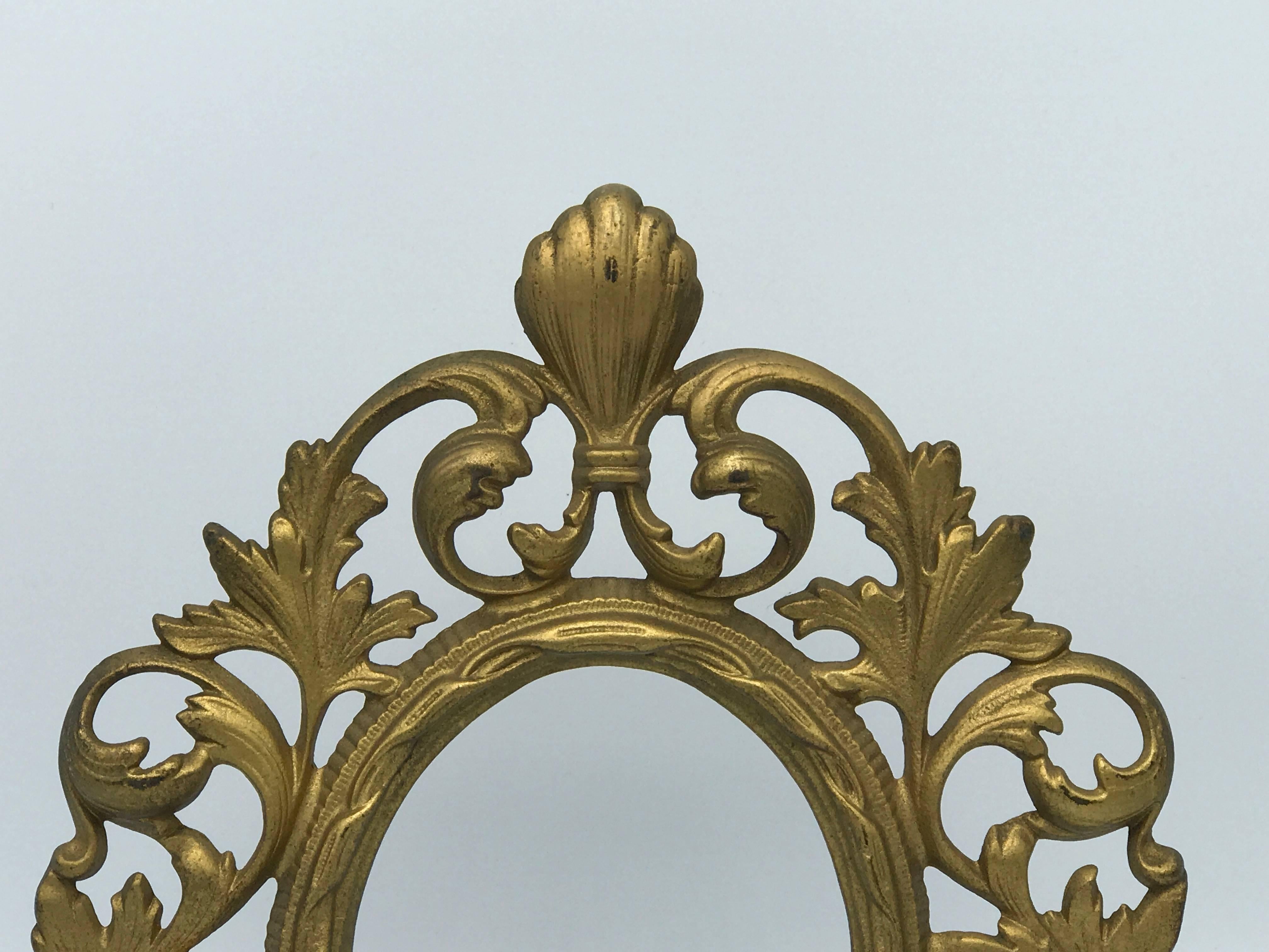 Offered is a stunning, 19th century gilt bronze standing picture frame. Glass not included.

Measures: Fits a 4" x 5" picture.