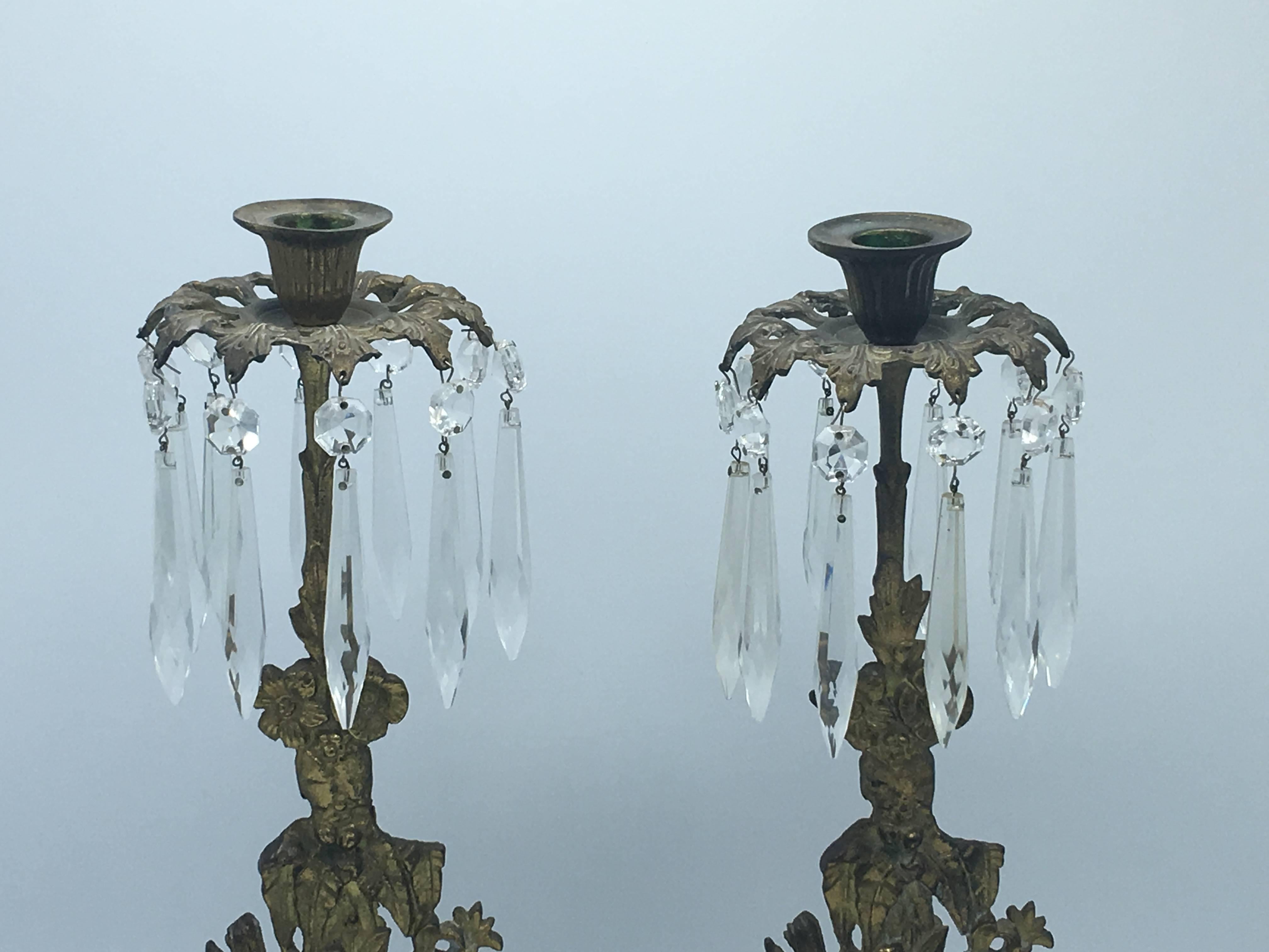Offered is a beautiful pair of late 19th century, brass and crystal flower basket girandoles with a white marble base. Each has ten strands of crystals, all original.