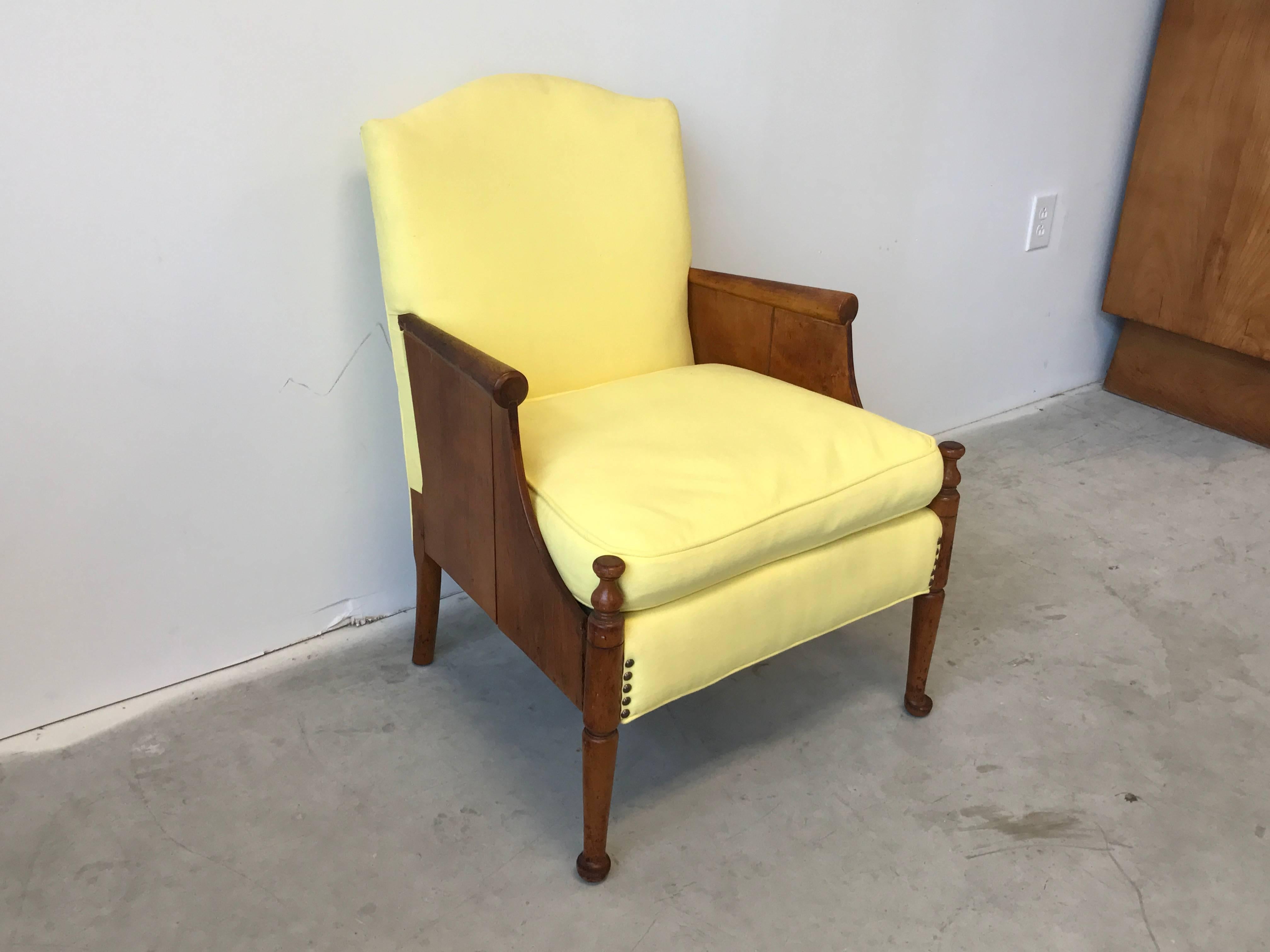 Offered is a stunning, 1940s French oak side chair. The piece is upholstered in a light-yellow and is filled with down inserts.
