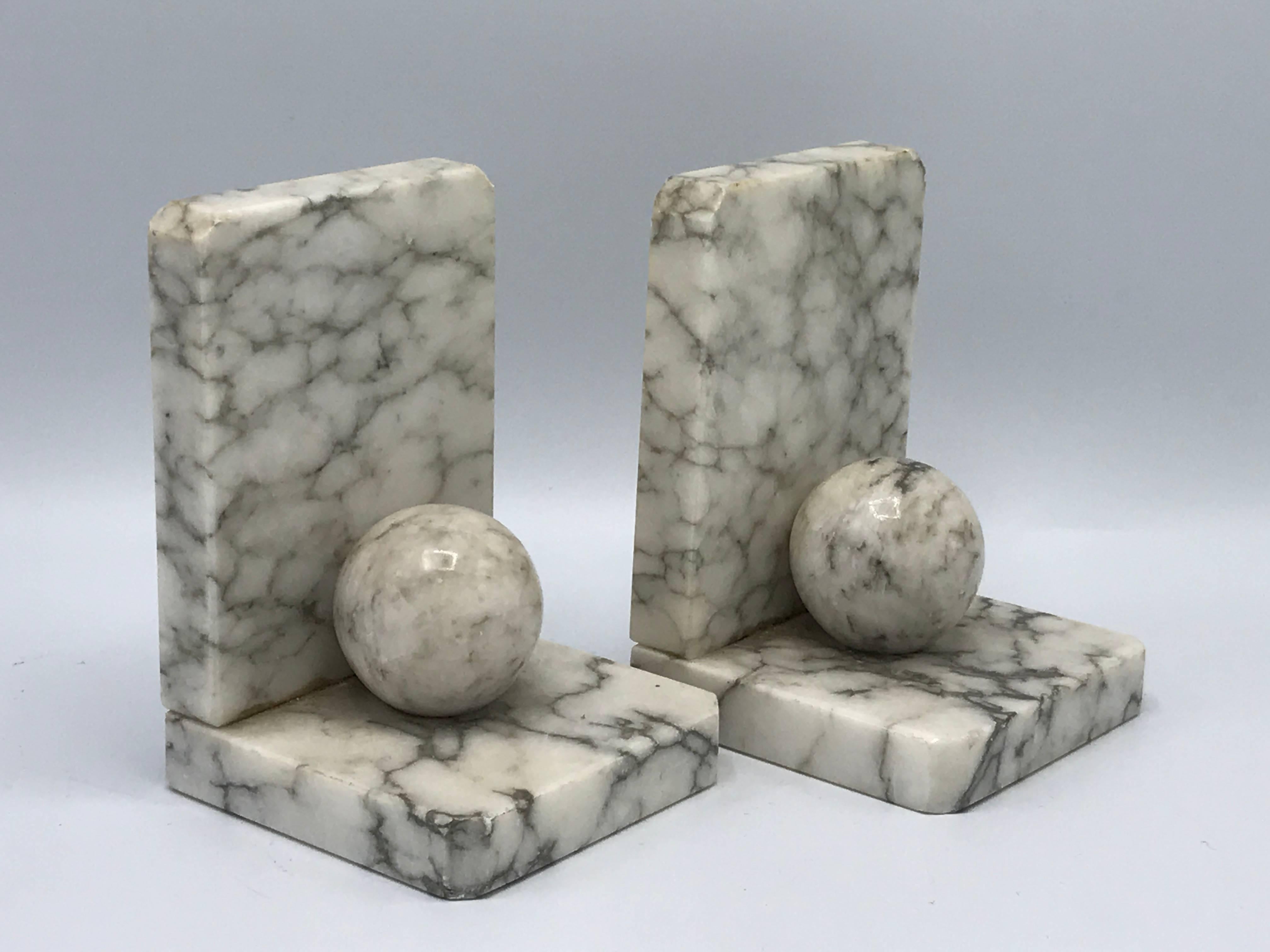 Offered is a stunning pair of 1940s, Italian, Carrara marble orb bookends. Marked, Made in Italy.