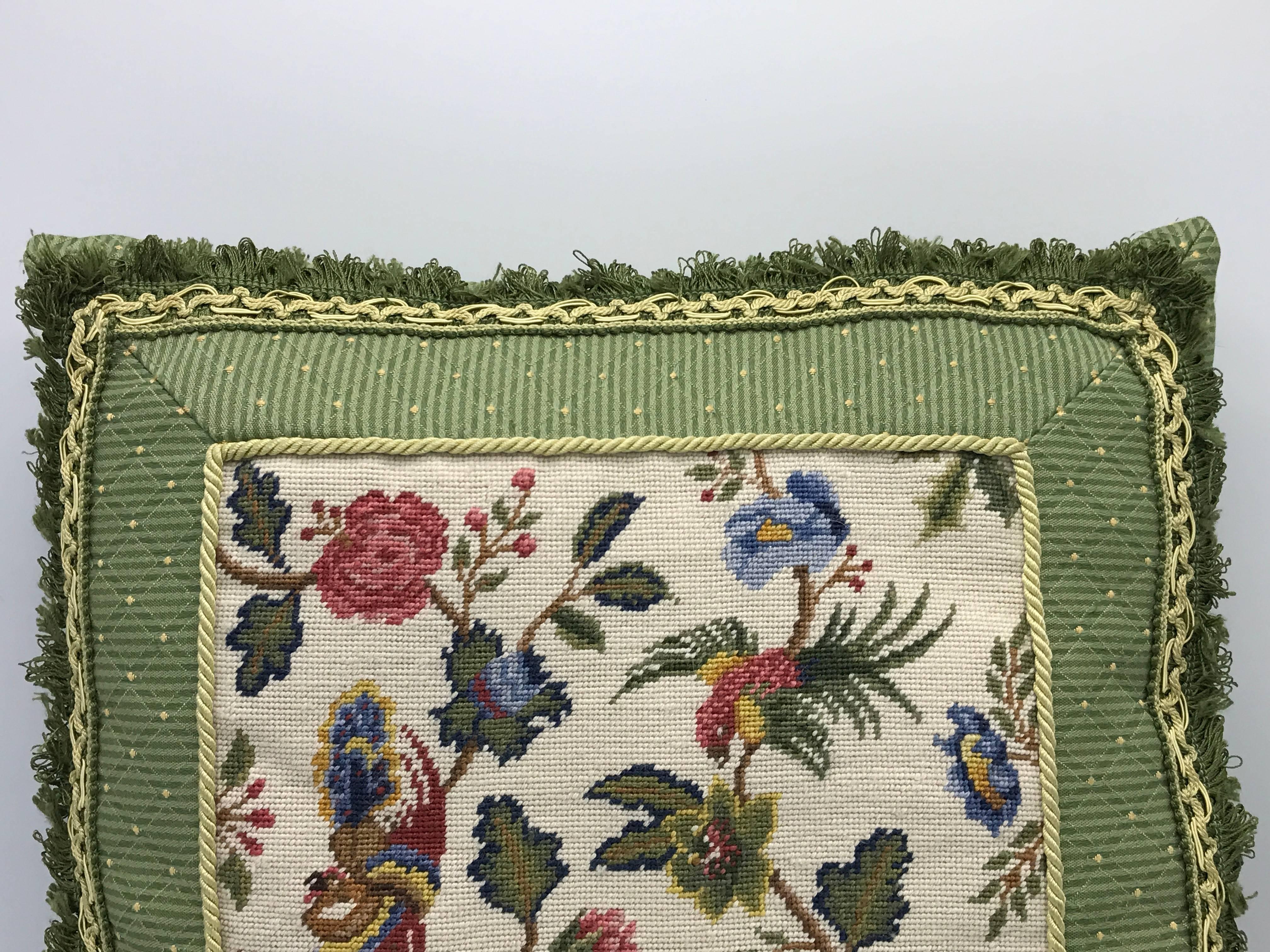 Offered is a beautiful, 1960s floral motif needlepoint pillow. The floral motif is complimented by a green band and backing.