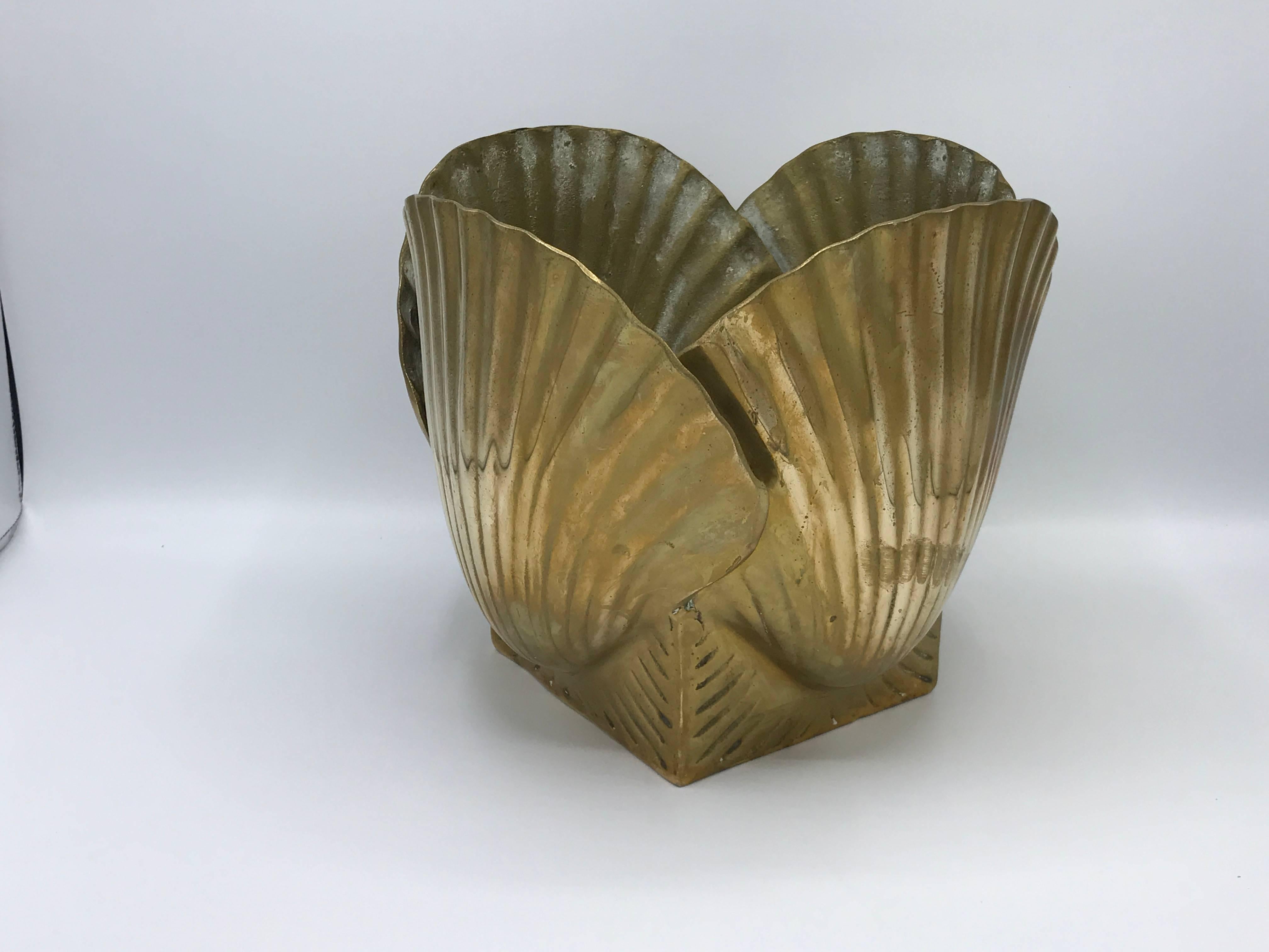 Offered is a stunning, 1970s Hollywood Regency and Palm Beach style, solid brass seashell cachepot planter.