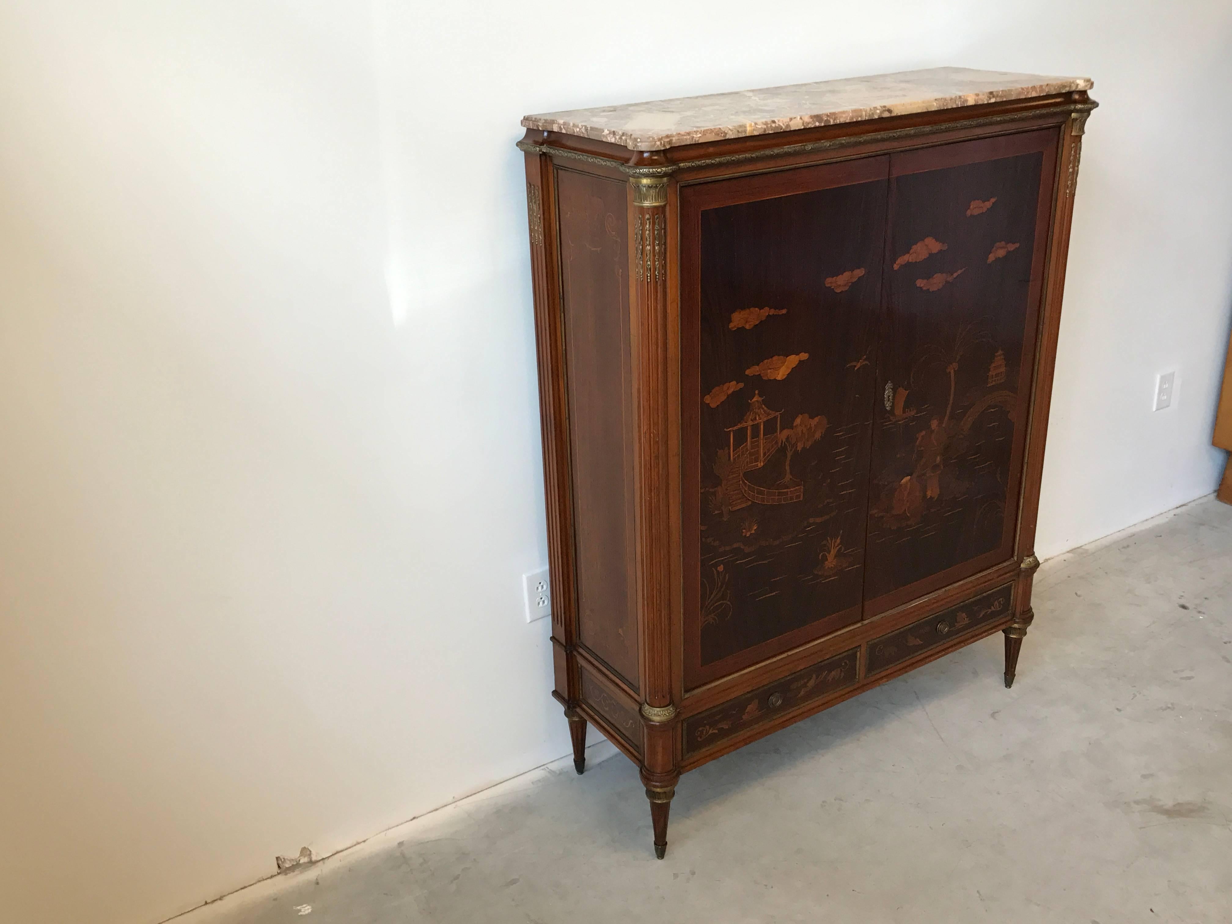 Offered is a stunning and extremely rare, 1940s Eugenio Diez walnut and mahogany chinoiserie dry bar cabinet with exotic wood inlay. The immaculate pieces exterior features intricate, ornate marquetry inlay, fluted sides extending to the legs,