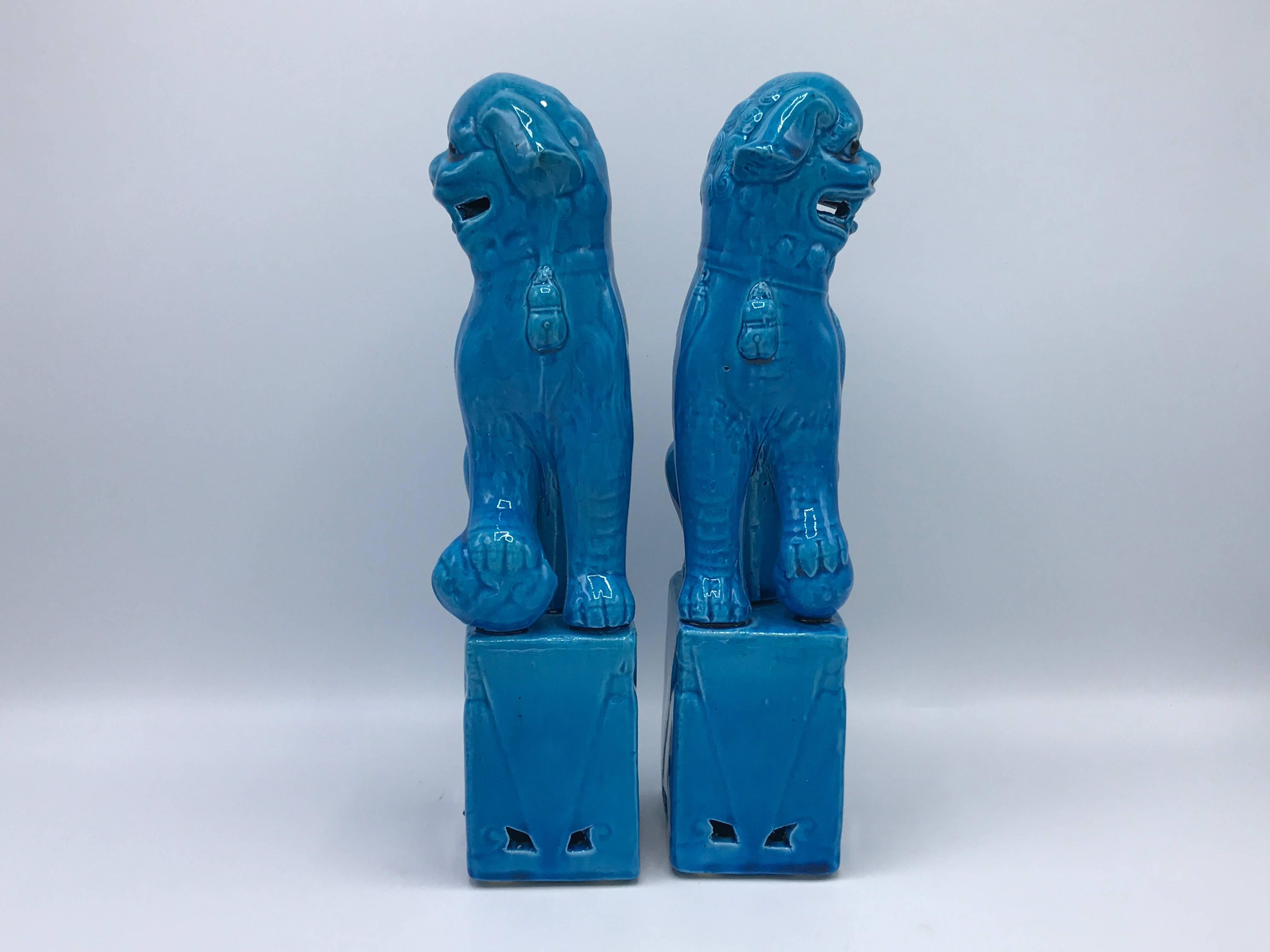 Offered is a stunning pair of 1970s turquoise glazed ceramic foo dogs.