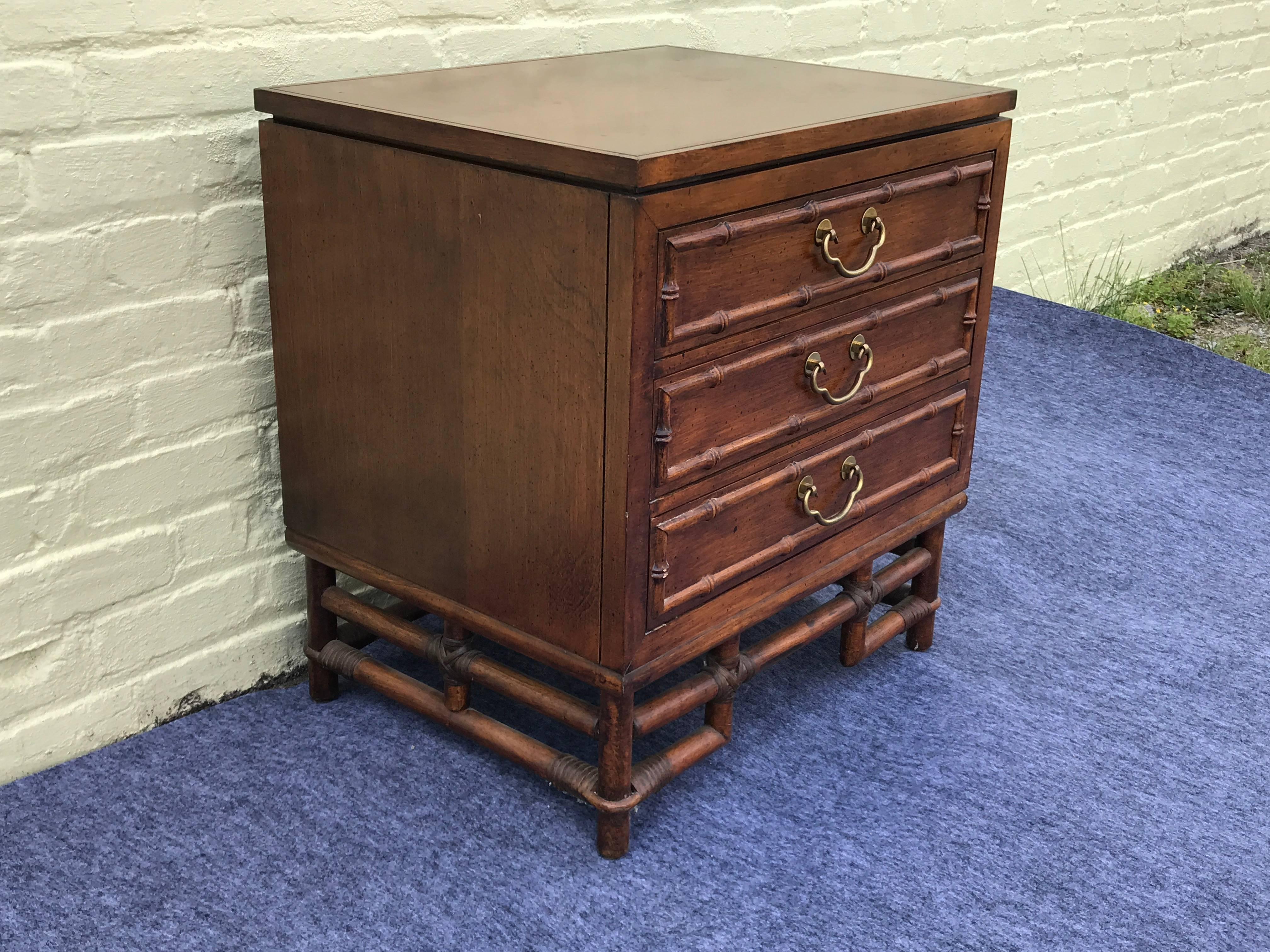 Offered is a beautiful, 1970s Ficks Reed bamboo side table with brass drawer pull detailing. Three drawers, top drawer marked with original label.