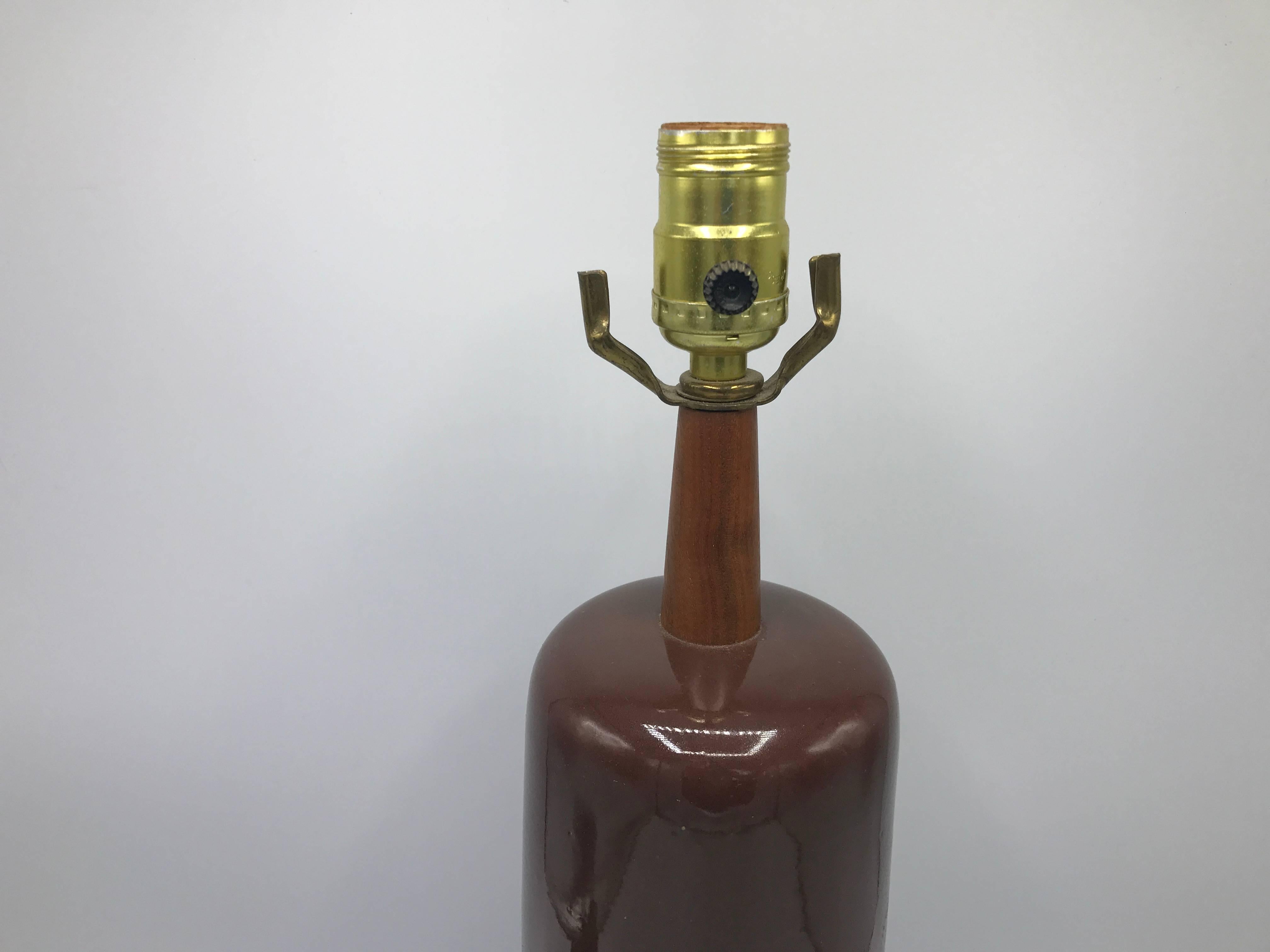 Offered is a stunning, 1960s Martz brown glazed ceramic lamp with teak accent. Signed on backside.