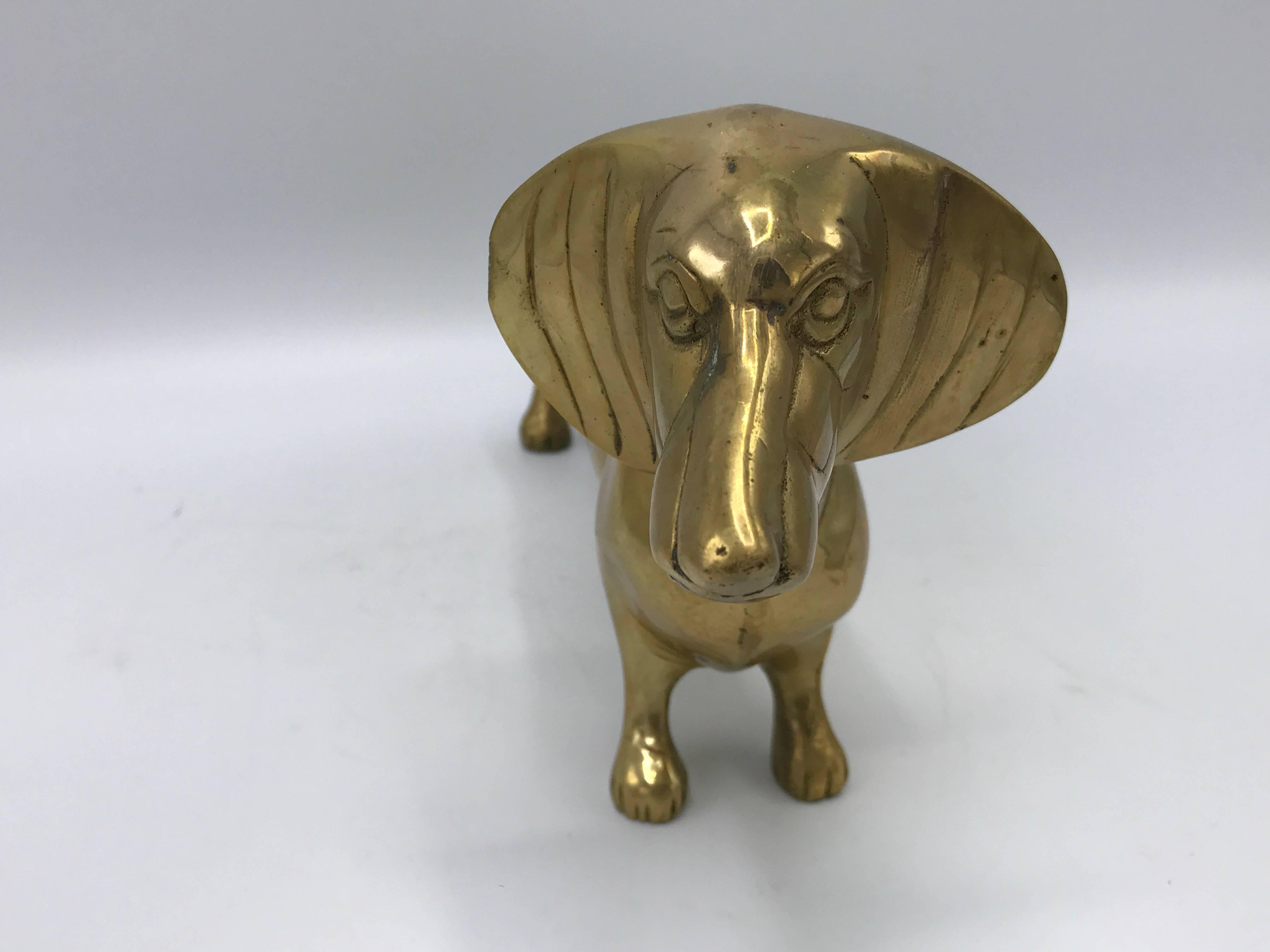 Offered is a gorgeous, 1960s solid-brass Dachshund dog sculpture. Can double as a door-stop.