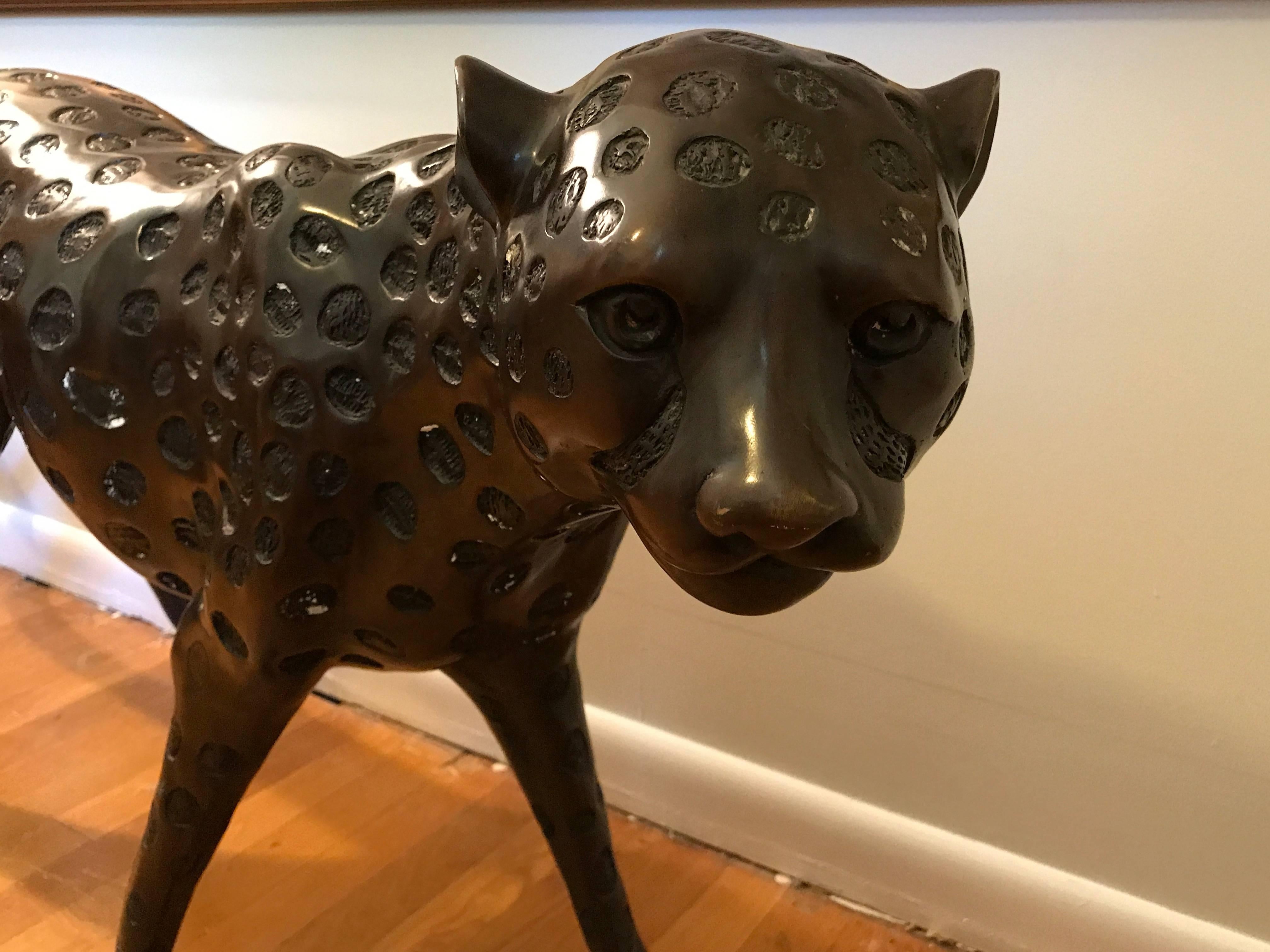 Offered is a stunning, 1970s French life-sized leopard sculpture. The piece is extremely heavy and sturdy... Difficult to weigh, due to its size. Needs two people to lift and move around. Bronzed metal. 