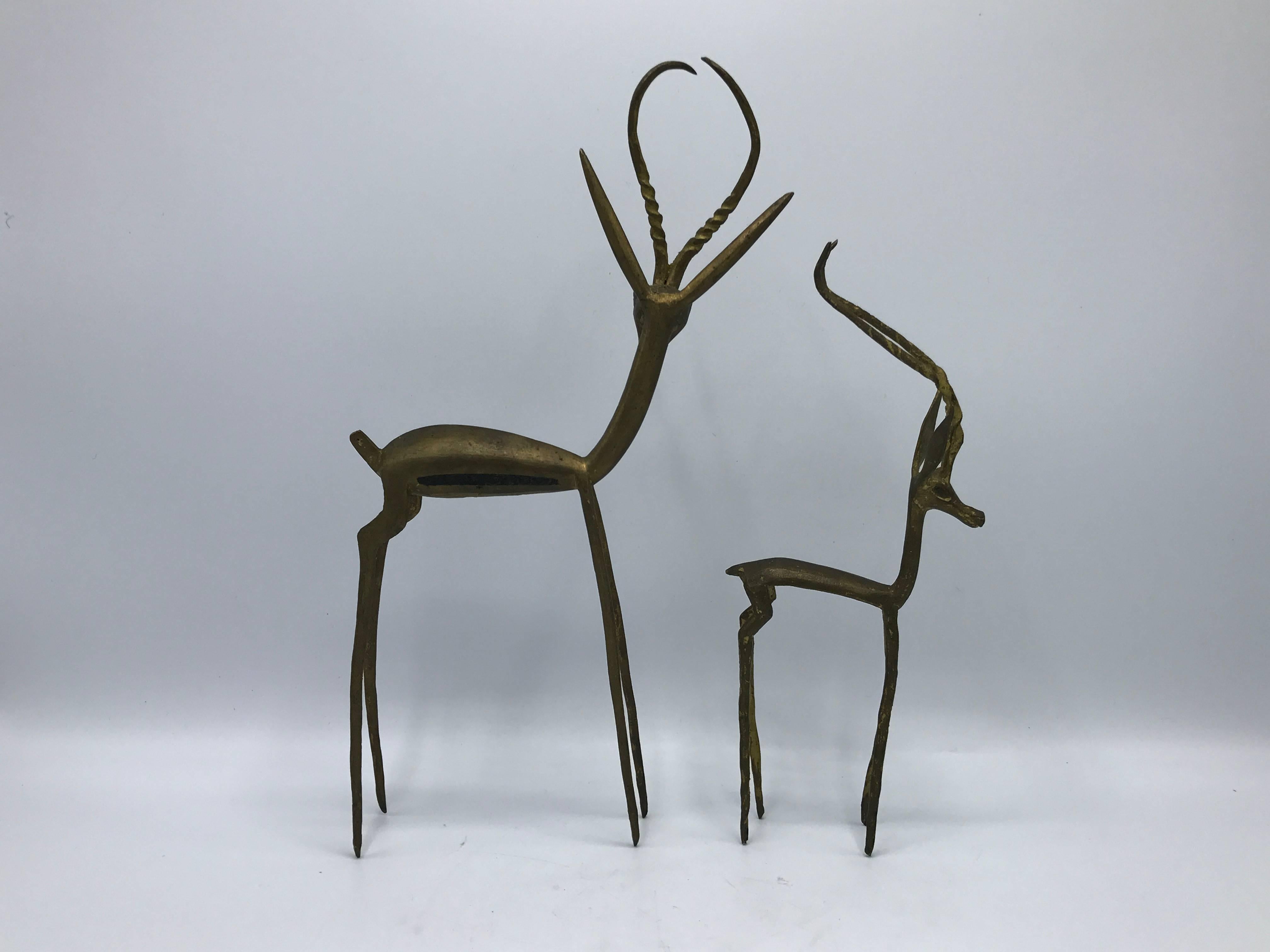Offered is a gorgeous pair of 1960s solid-brass, modernist gazelle sculptures. 

Measures: Large 2