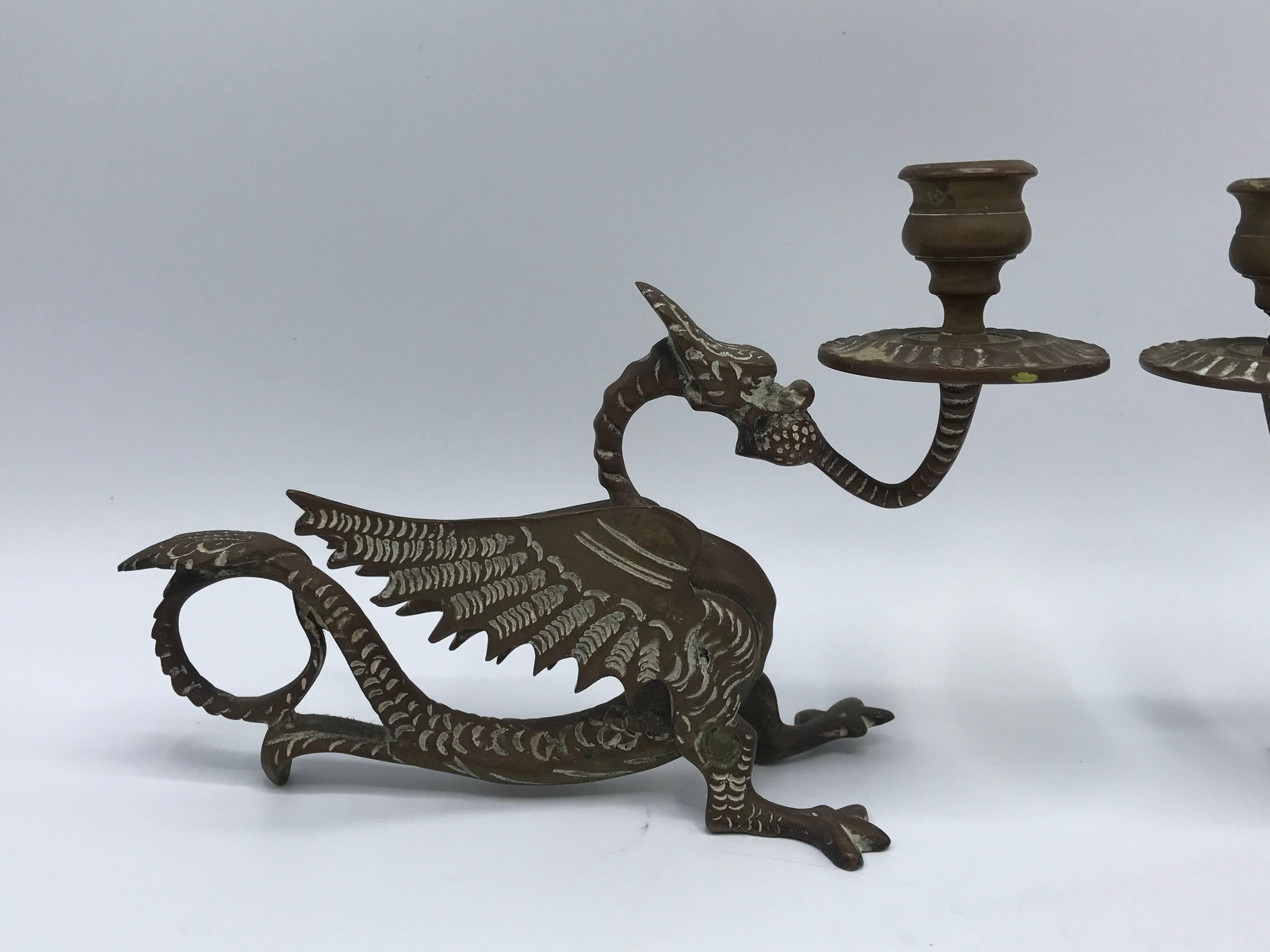 Offered is a stunning, pair of late 19th century solid-bronze dragon foo dog candlestick holders.