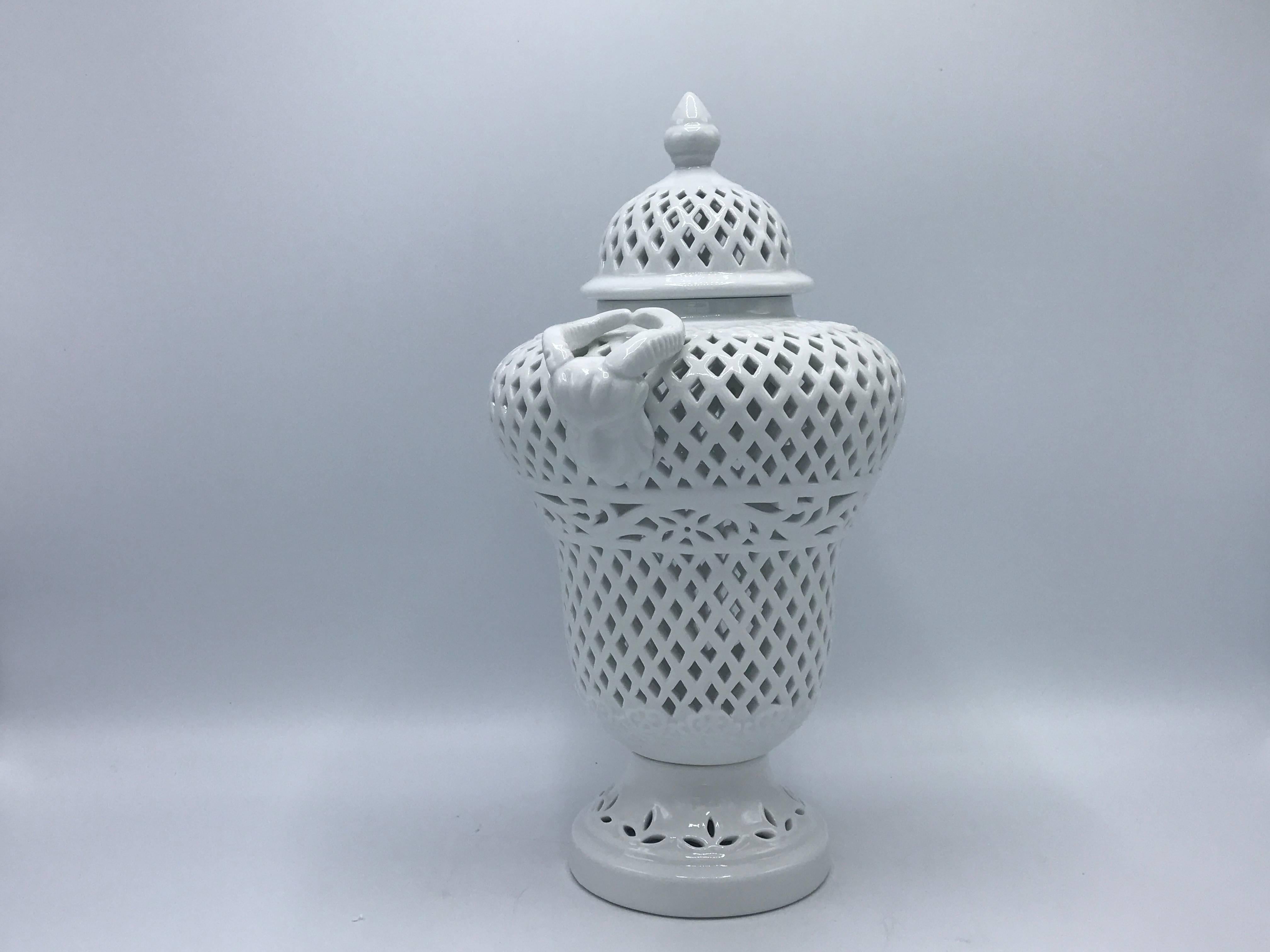 Offered is a beautiful, 1960s blanc de chine pierced urn. Lidded, with ram head handles.