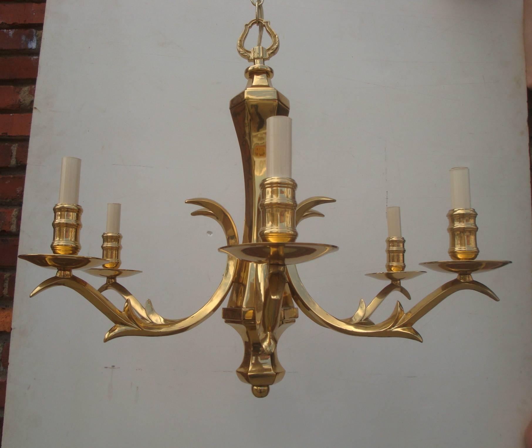 Offered is an amazing, 1970s polished brass chandelier with six lights and branching arms that resemble deer antler points. The center body is a curvy six-sided shape, and the arm branches are squared tubes rather than round, giving the piece a