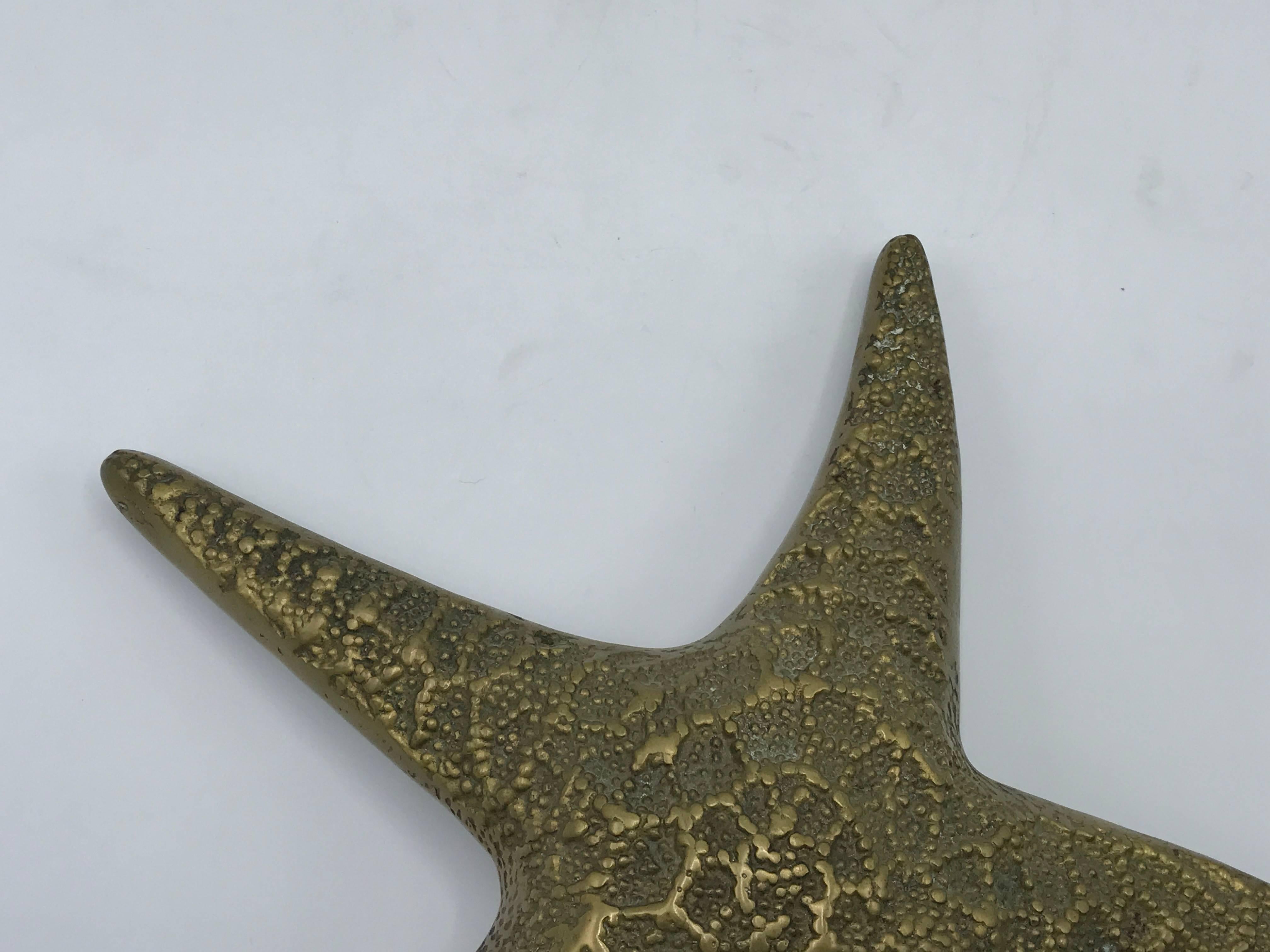 Offered is a stunning, 1960s solid-brass starfish sculpture. Hook on backside to hang.
