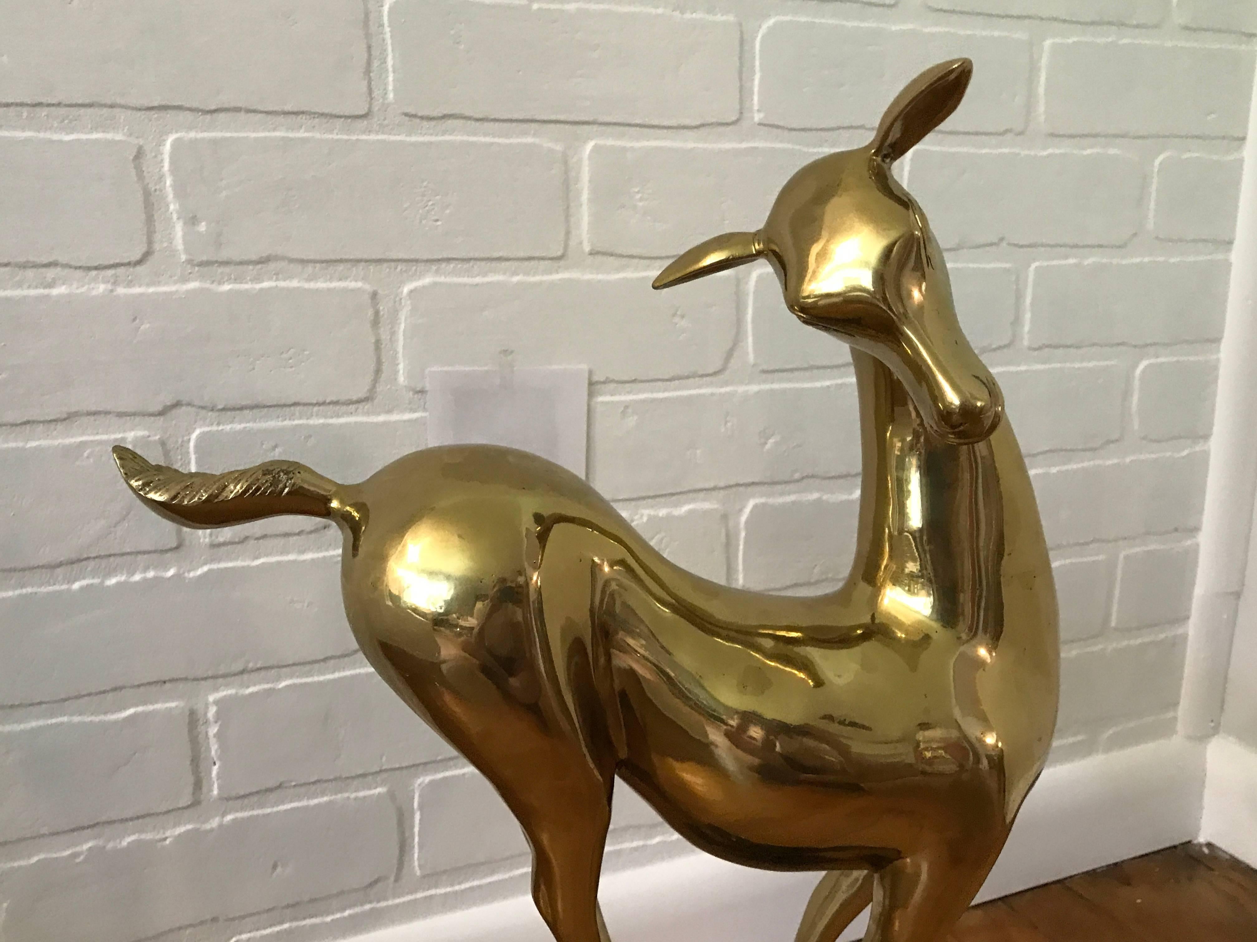 Offered is a stunning, 1960s modern Italian brass deer sculpture mounted on a lacquered base. Heavy.