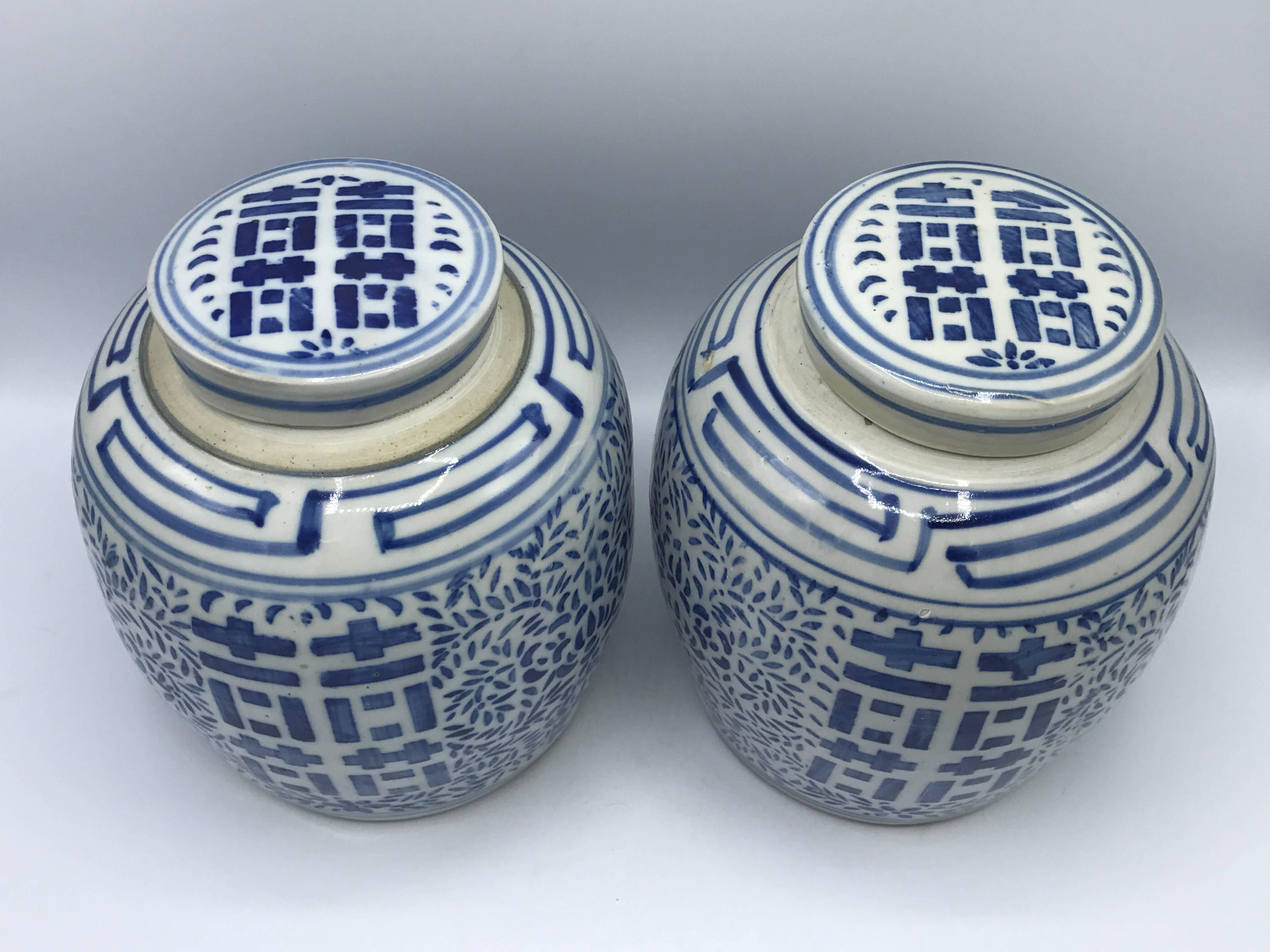 Offered is a gorgeous pair of 1960s blue and white double happiness ginger jars. Small chips on underside of lids. Excellent condition, no cracks.