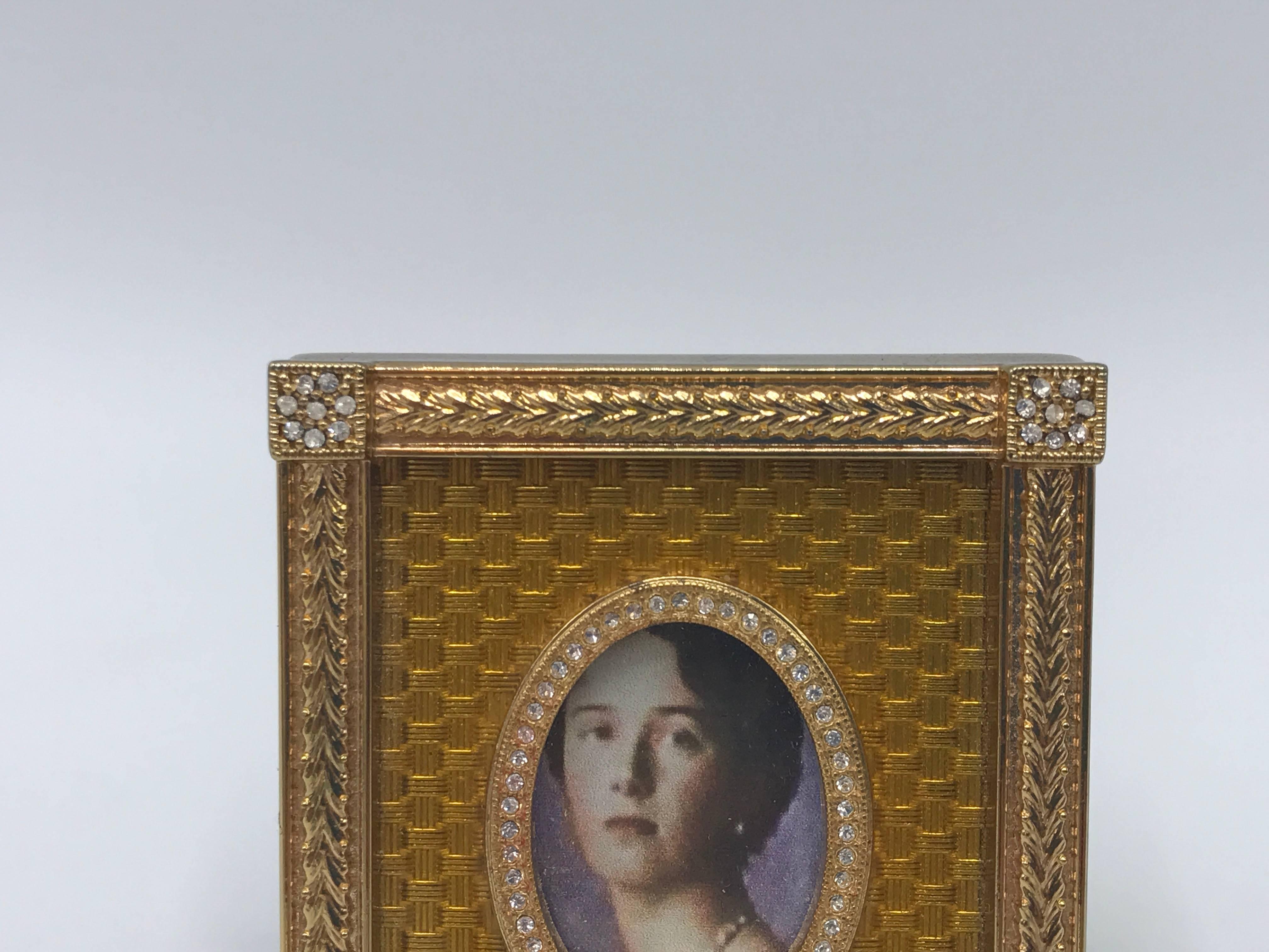 Offered is an absolutely stunning, Faberge yellow 'Catherine Palace' style picture frame from a limited edition release in the early 1990s. A miniature frame matted in a basket weave enamel guilloché pattern, enclosed by an outer laurel-leaf design