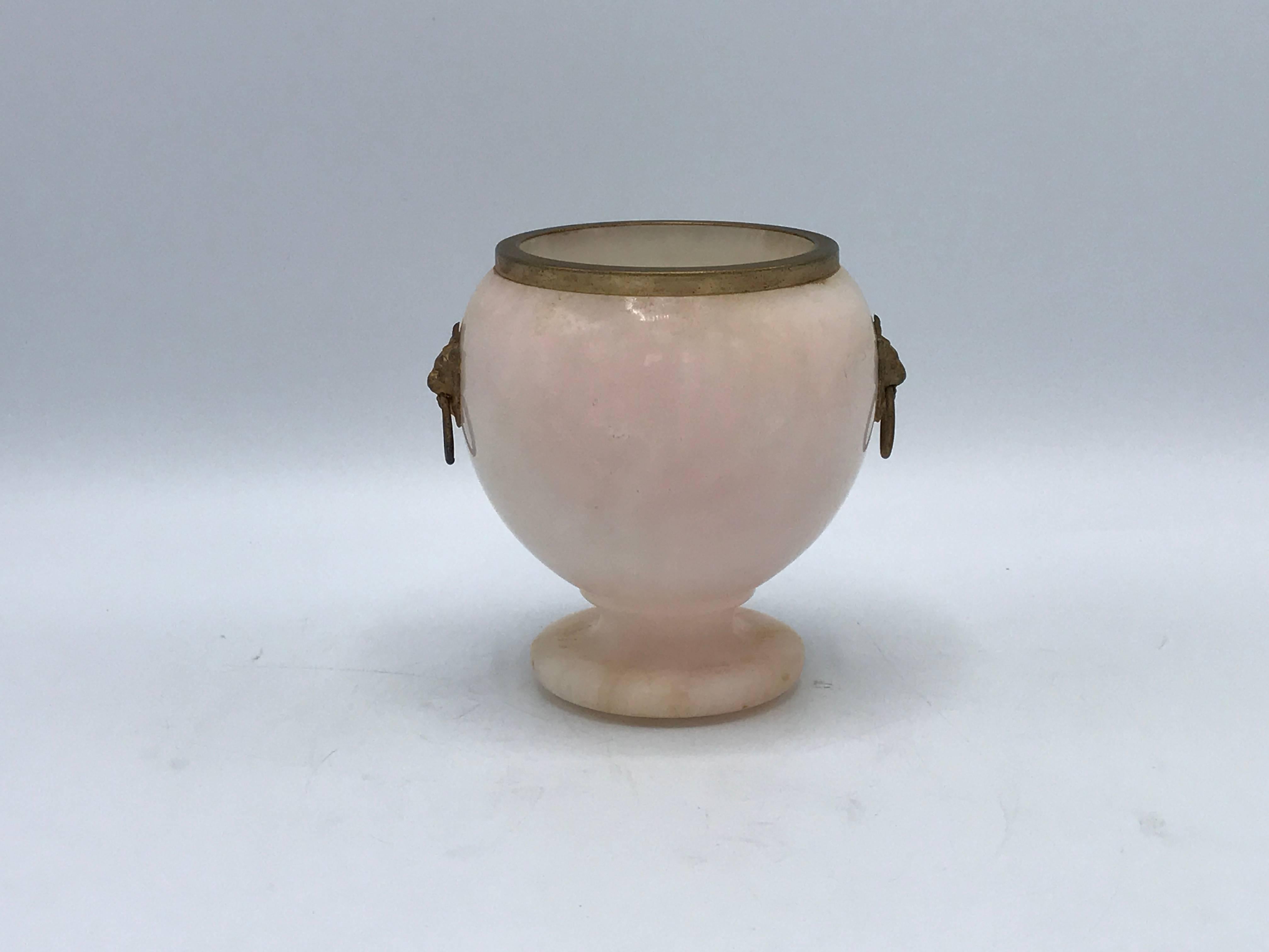 Offered is an elegant, 1950s Mid-Century Italian alabaster urn with brass lion head handle hardware and lip.