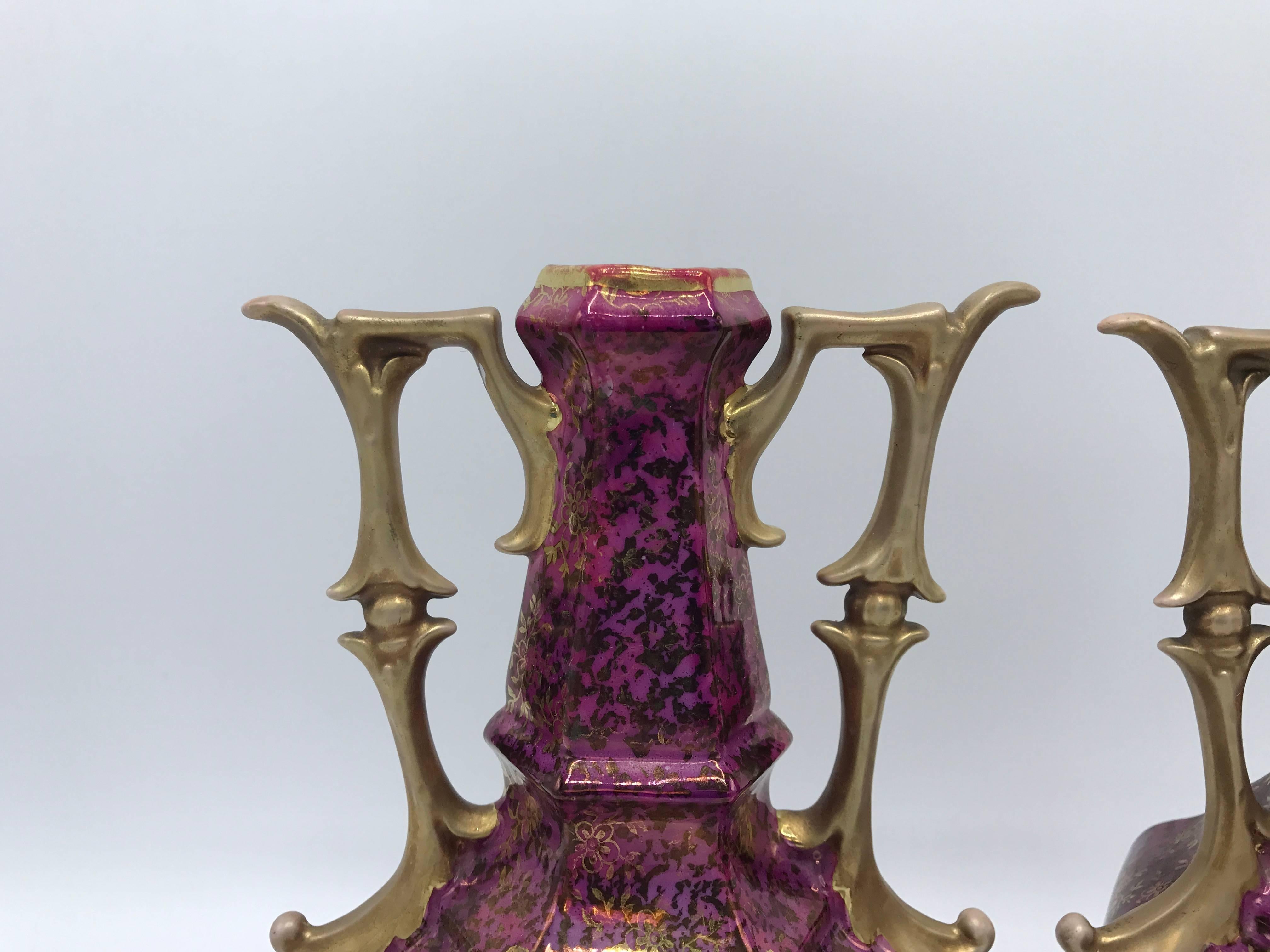Offered is a gorgeous, pair of 19th century French hand-painted pink and gold vases with handles. Each vase has a different hand-painted scene on the front.