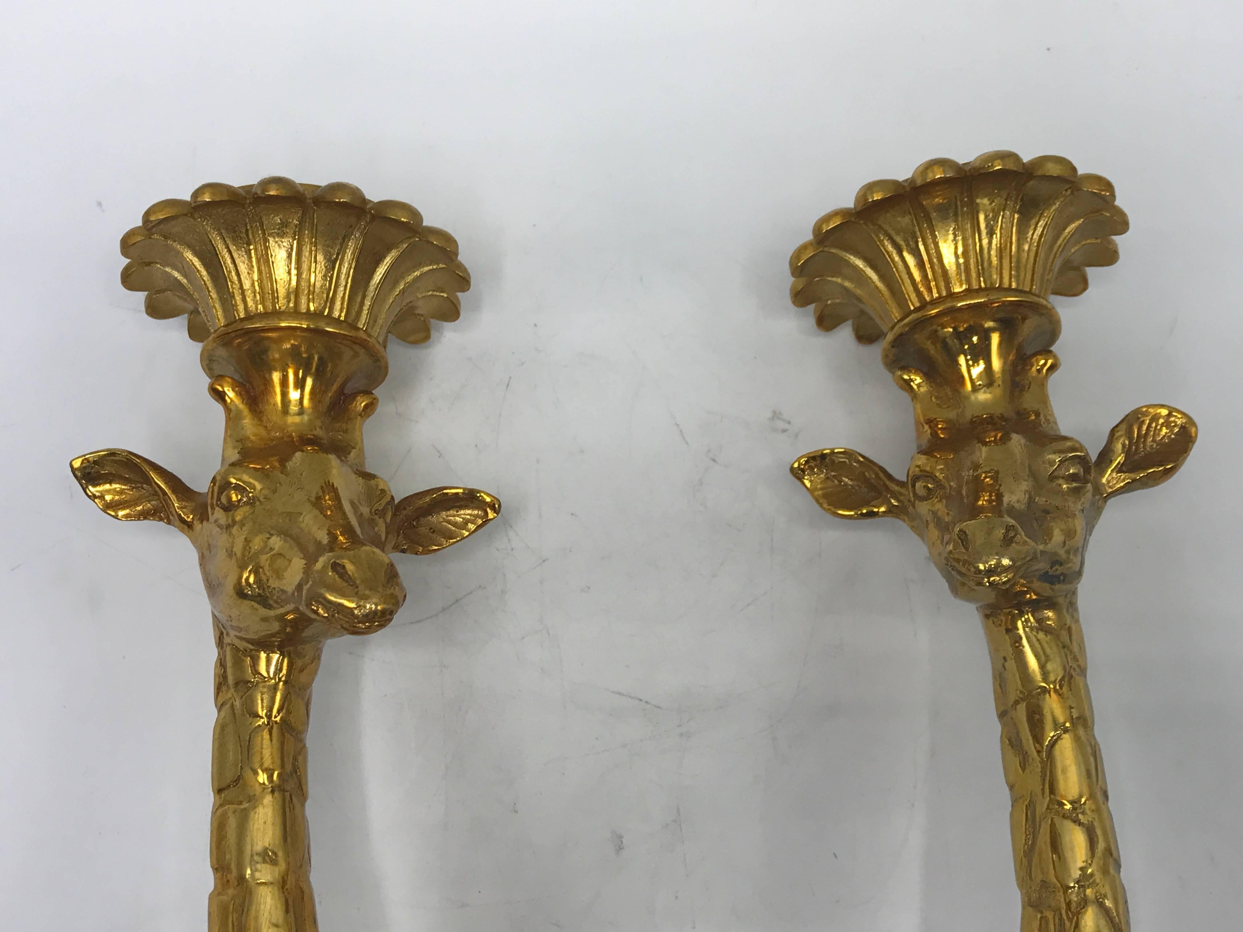 Offered is an absolutely fabulous pair of 1970s Italian gold-plated brass giraffe candlestick sconces. Extremely heavy. Original sticker on backside. They have never been used before.