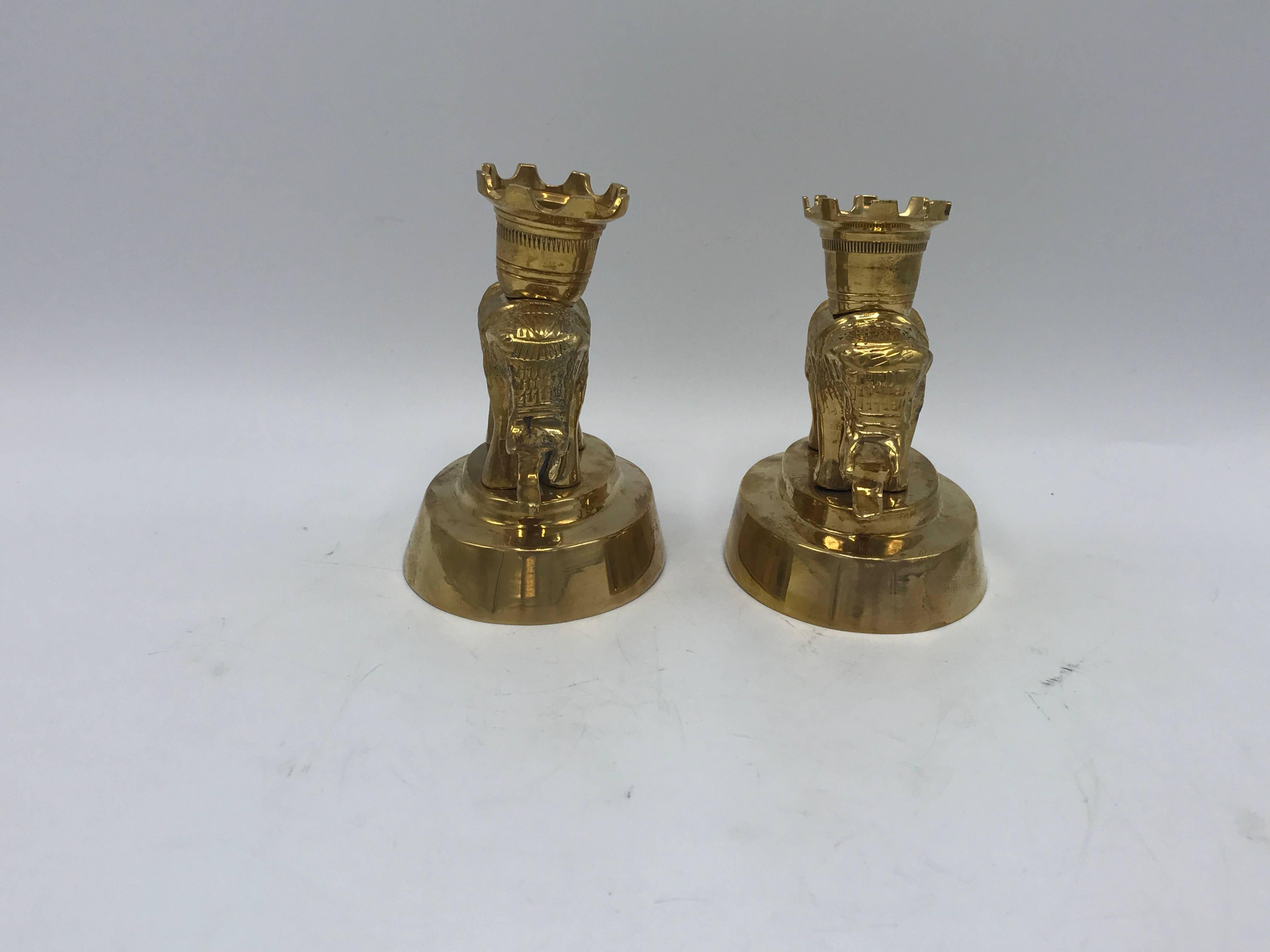 Offered is a beautiful, pair of 1970s Mottahedeh solid-brass elephant sculpture candlestick holders. Original tag on underside of one elephant. Heavy.