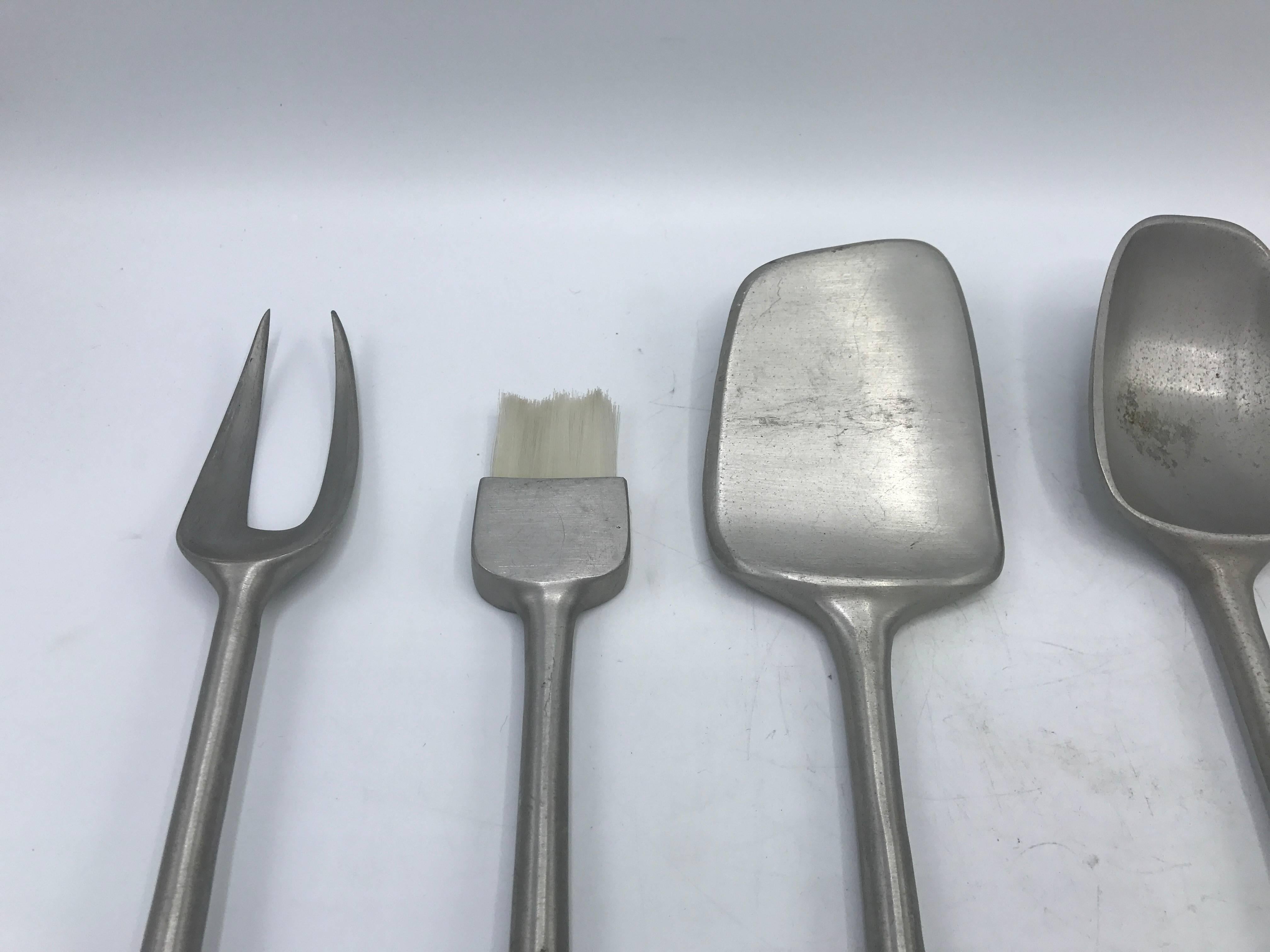Offered is a fabulous, set of five, 1960s Mid-Century Modern teak and aluminum grill tools. Looks as if the set has never been used.