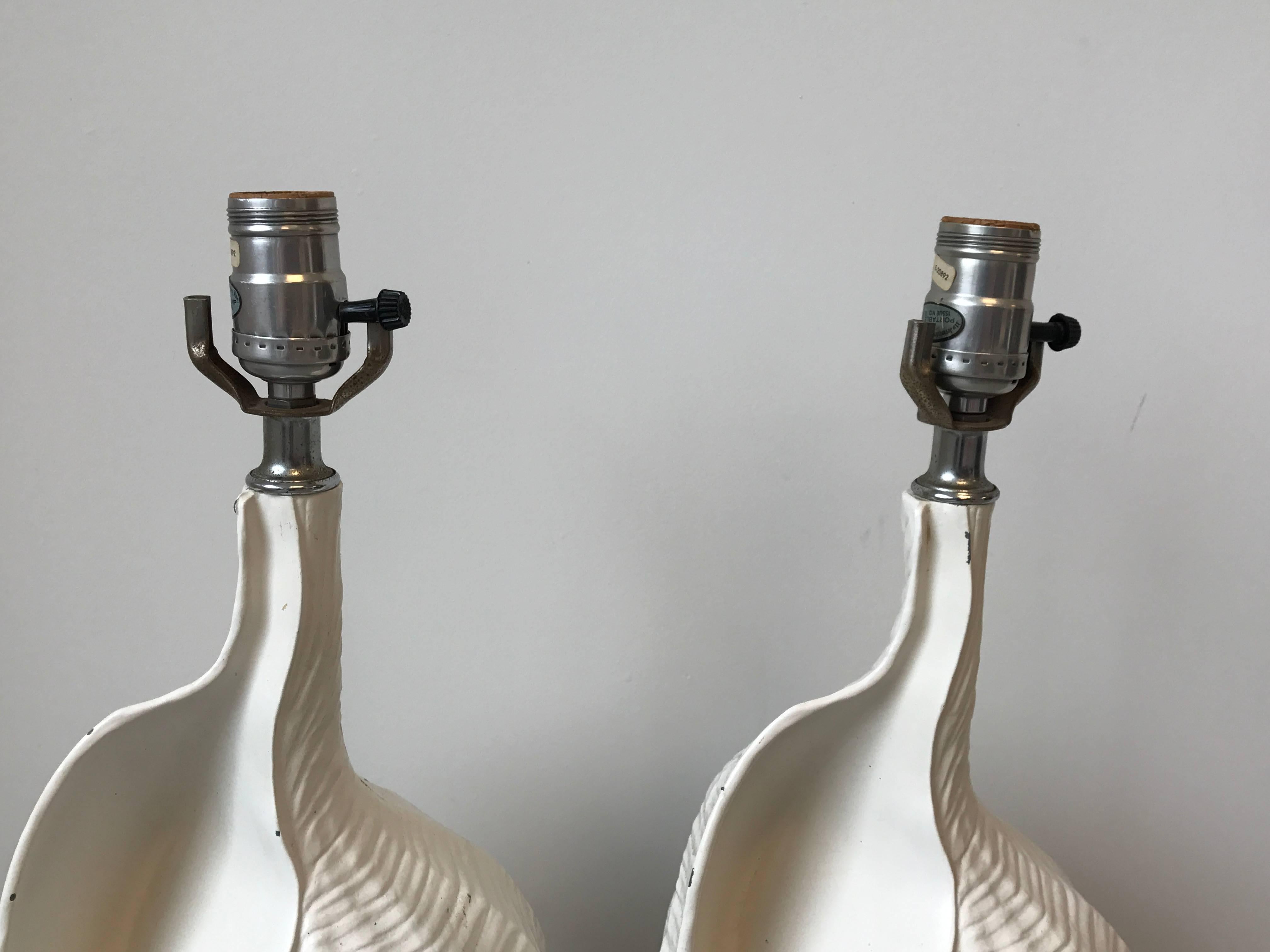 Offered is a fabulous pair of 1950s Palm Beach and Hollywood Regency style, cast-aluminum and chrome seashell lamps.