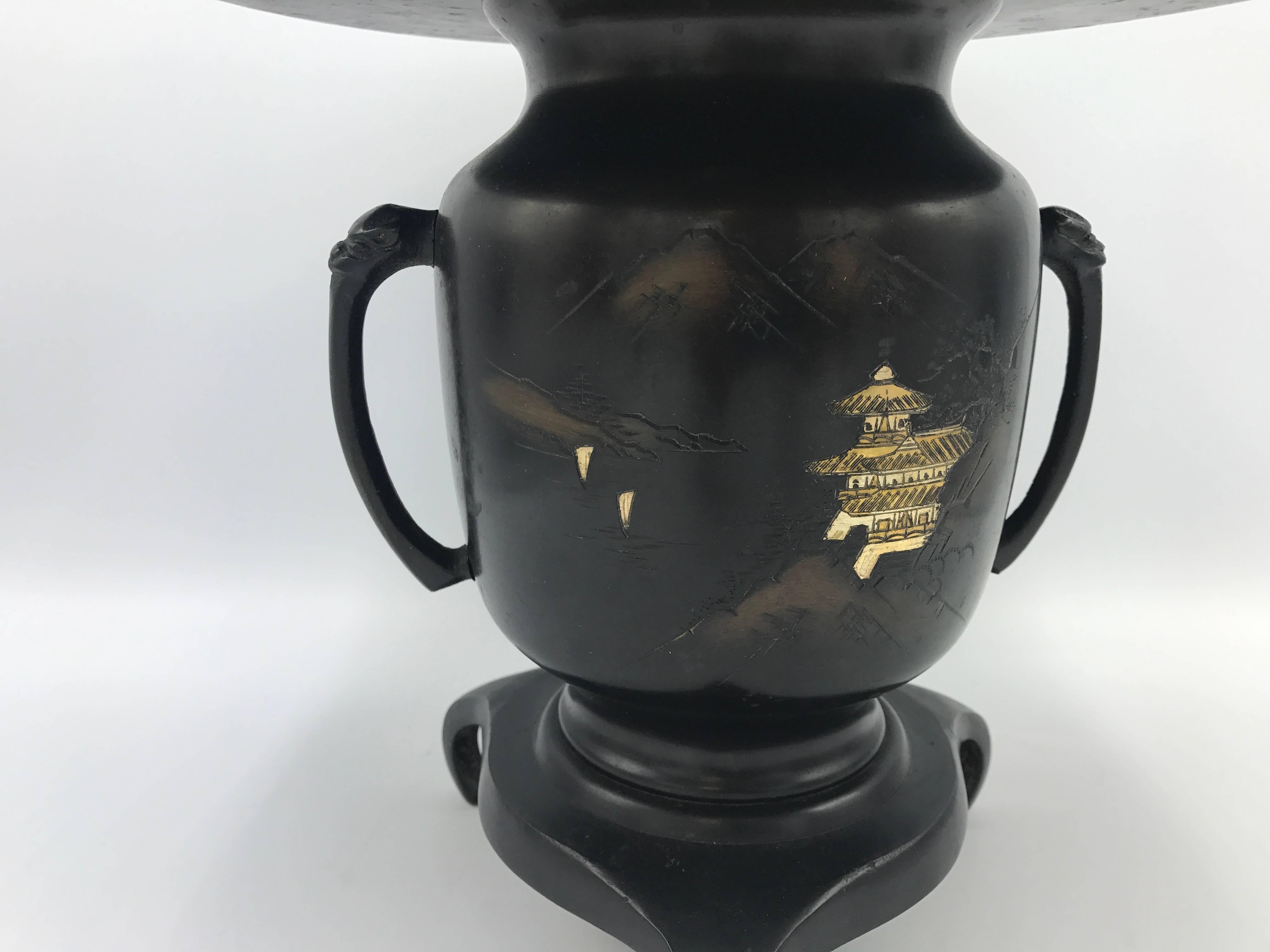 Offered is a gorgeous, 1930s Asian flower frog. The piece has a beautiful pagoda motif, removable lid, and is handled. 

Without lid: 8.75