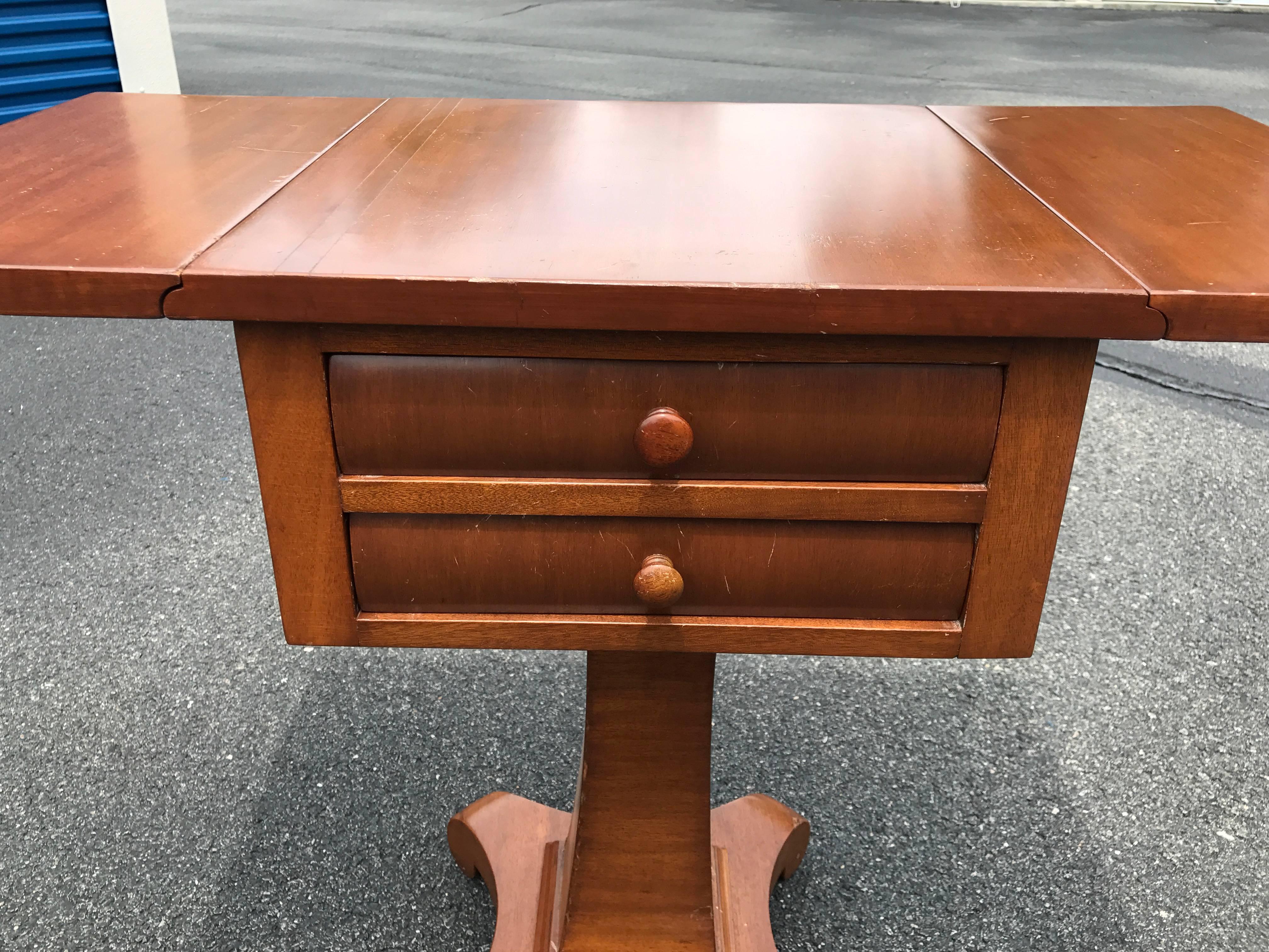 Offered is a gorgeous, 1930s English flip-top side table with two drawers. Freighted from England.

Max width of 35" with both sides up.