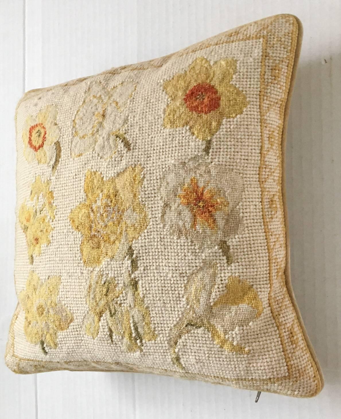 Beautiful handmade wool needlepoint pillow by the esteemed Chelsea Textiles, featuring flowers of daffodils and jonquil blossoms. Velvet back with down insert, zipper closure.