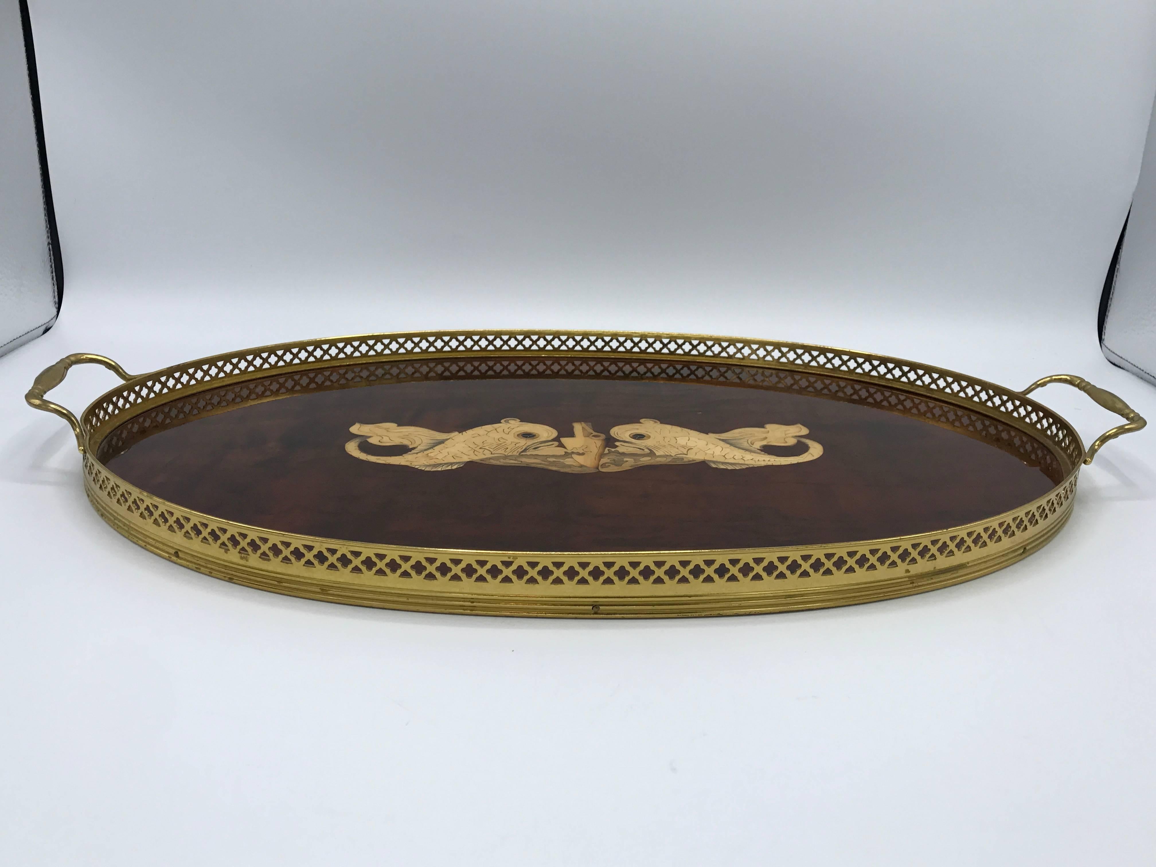 Offered is an exquisite, 1950s Italian inlaid serving tray. The piece has a gorgeous inlaid koi fish motif and is complimented by a brass gallery wall with handles. Lacquered.