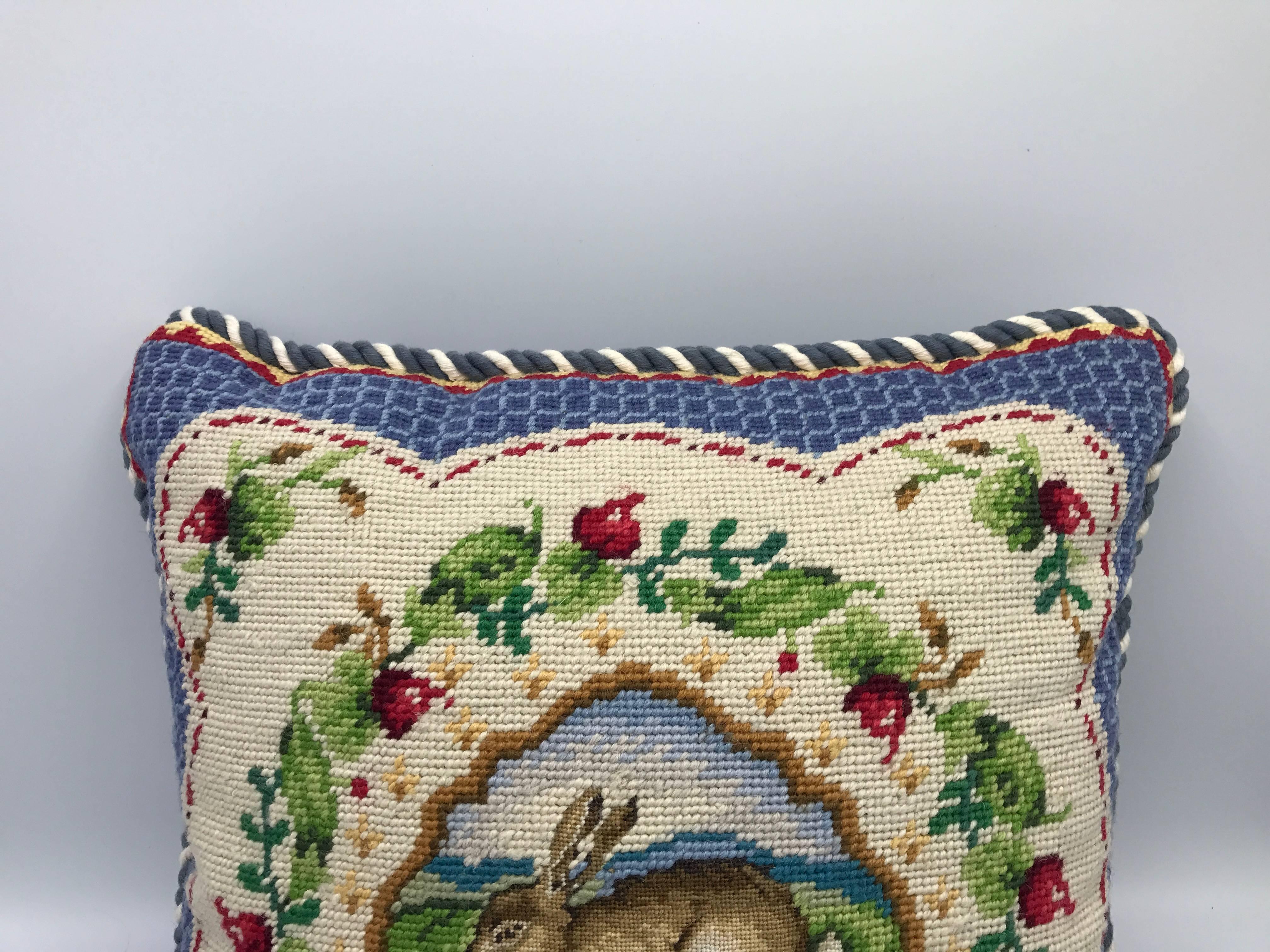 Offered is a stunning, blue and white needlepoint pillow, circa 1960s. The pillow has a floral and rabbit/hare motif. Blue and white piping on all sides. Velvet backing. Poly-blend insert. Zipper closure.